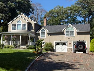 Onyx Black Shingle Roof Replacement for Melville Two-Story Residence