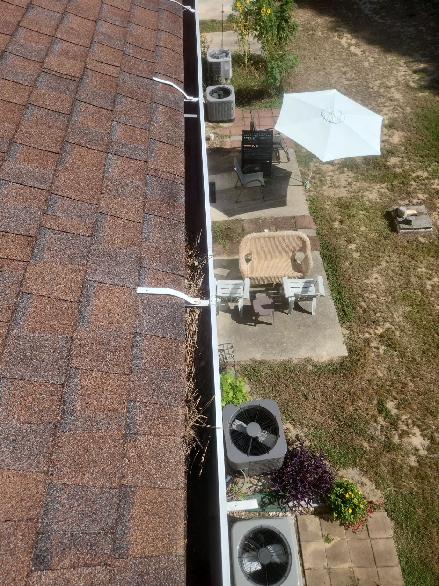 Commercial gutter cleaning Outer Banks & Kill Devil Hills before photo with filled gutters