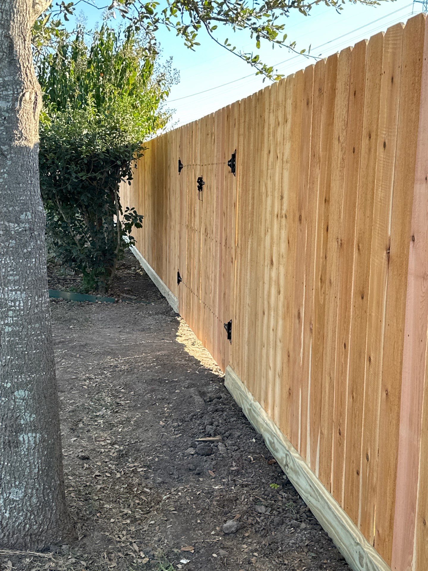 Beautiful Wood fence with metal posts by Tim's Fences