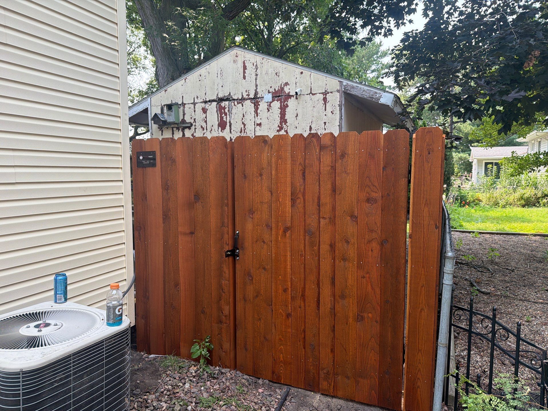 Pecan Cedar Privacy Fence Installation with Scalloped Top in Cedar Falls by Perfect Picket Fence and Stain