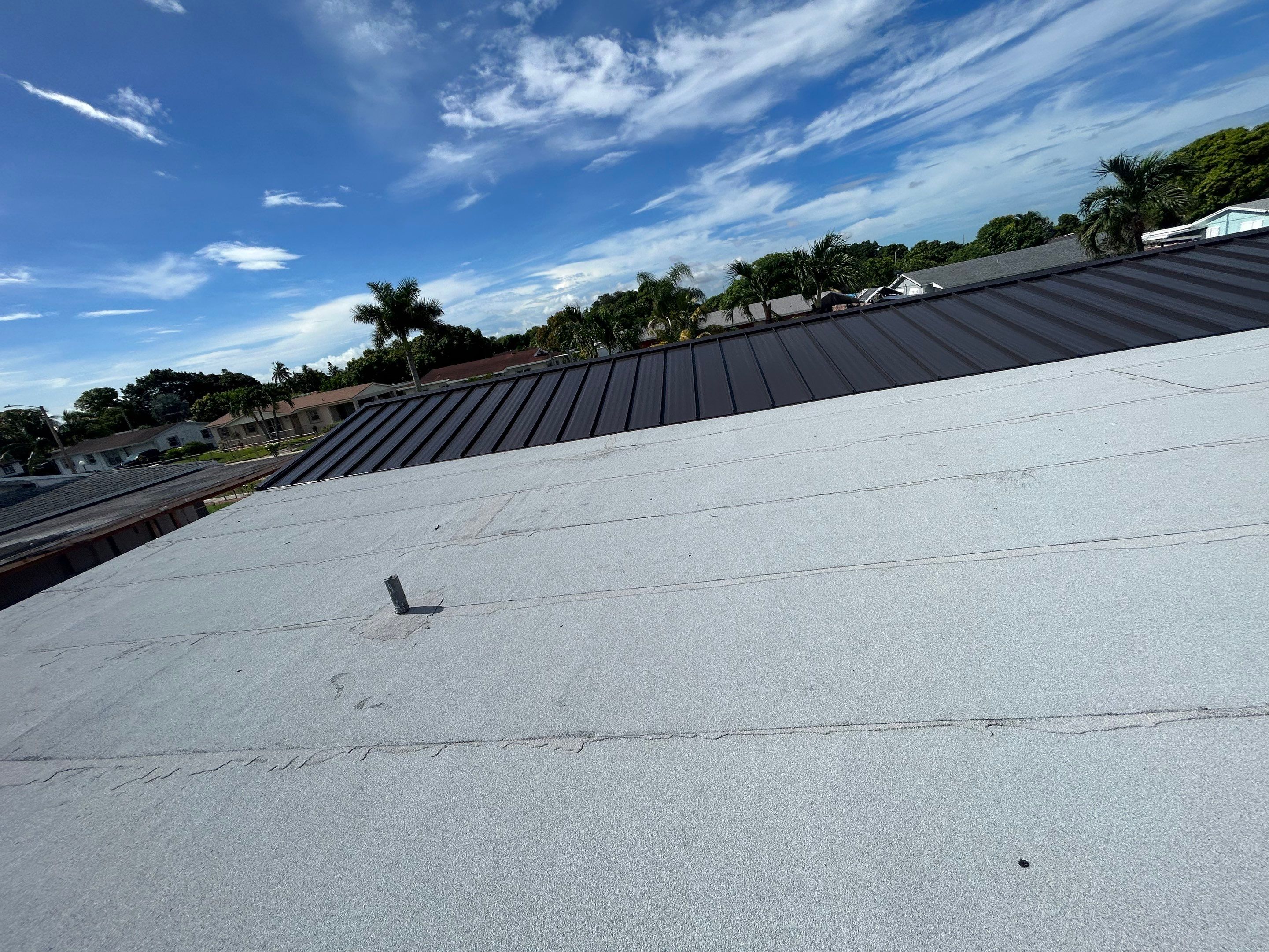 Shingle to Metal with Flat Reroof by SSI Roofing and Construction