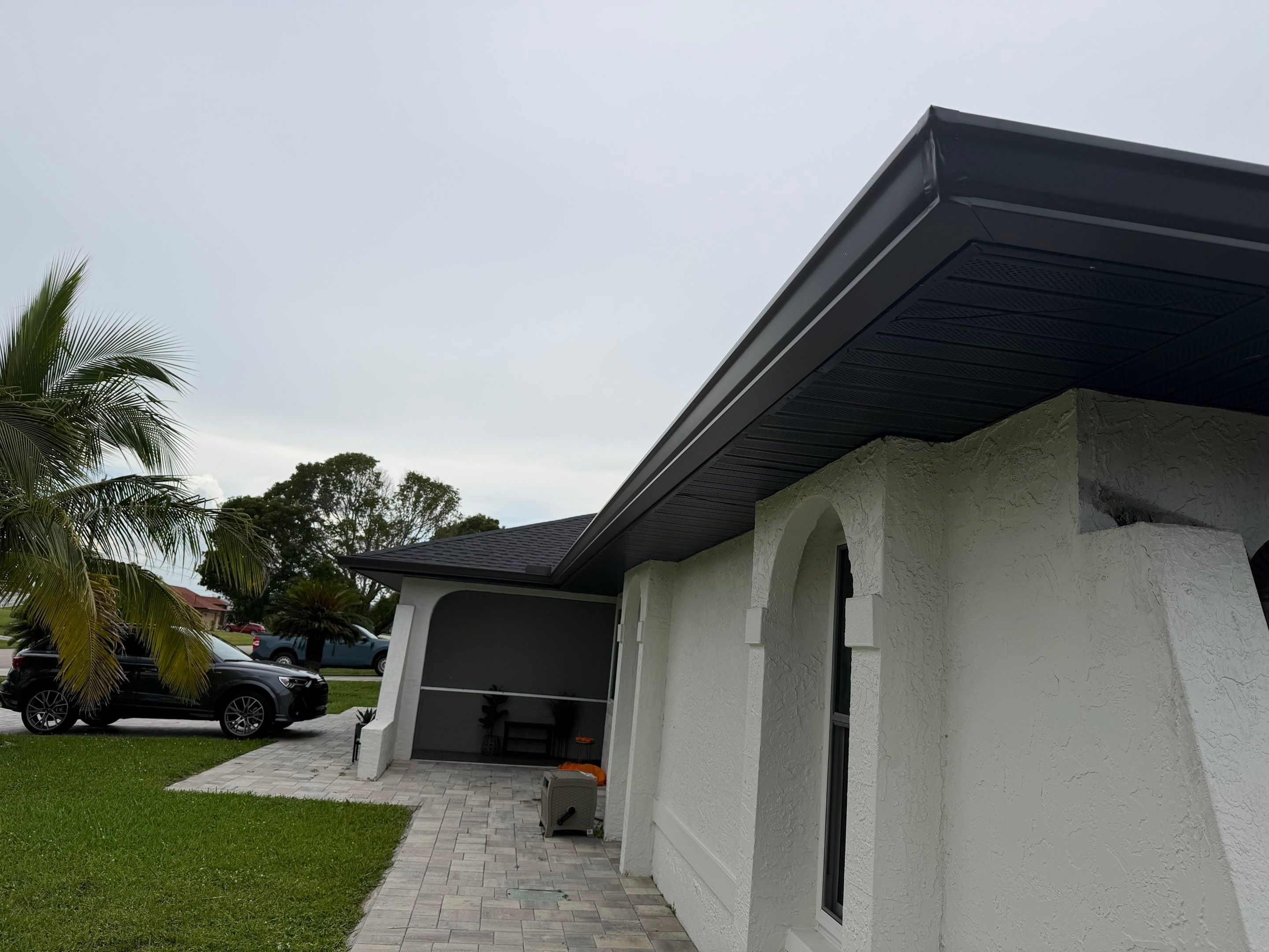 Black Seamless Gutters for a Modern Look in Cape Coral FL by Gutter Professors