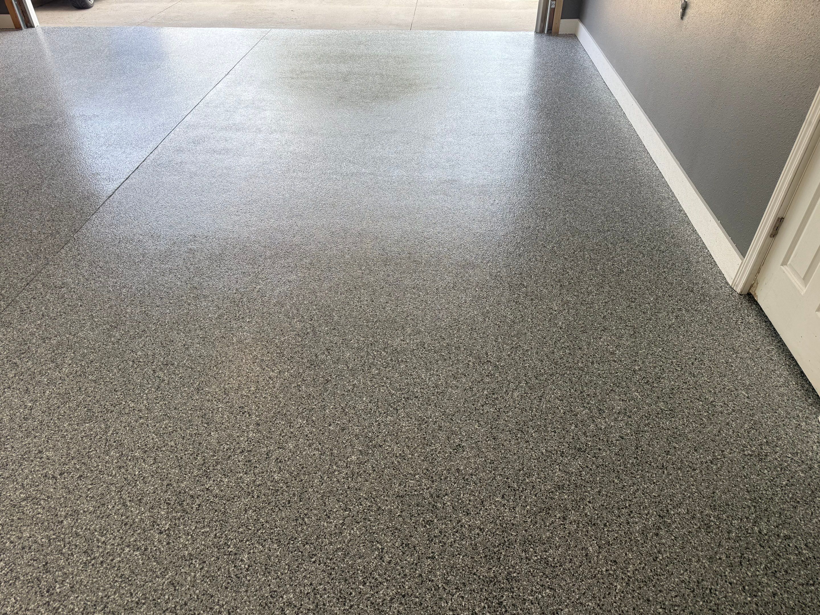 Custom Garage Floor Coating and Backyard Patio Refinishing in Tyndall by Select Painting, Coatings & Garage Cabinets
