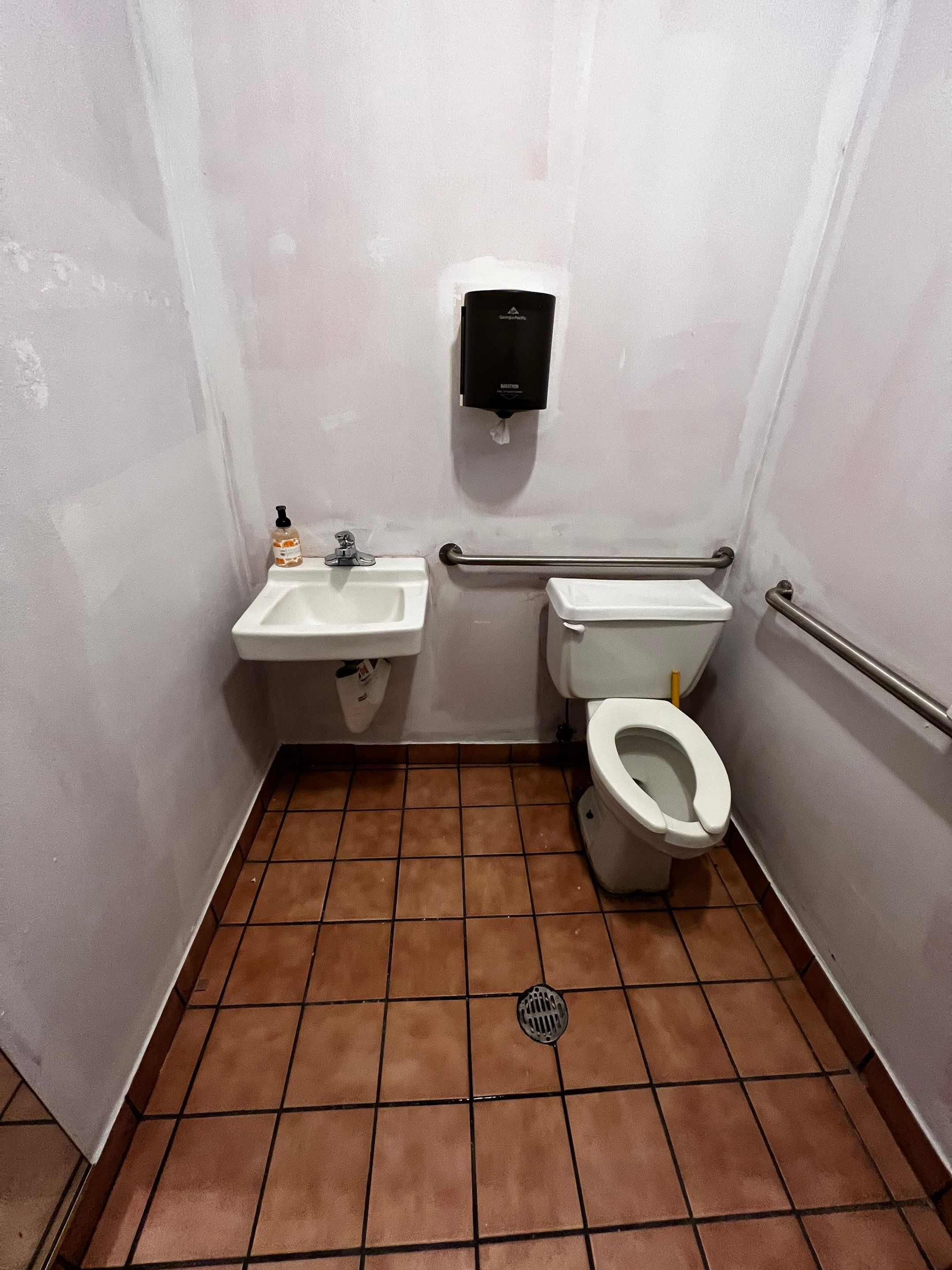Commercial Restaurant Restroom Renovation Featuring Patterned Wallpaper in Smyrna by Swift Home Renovations