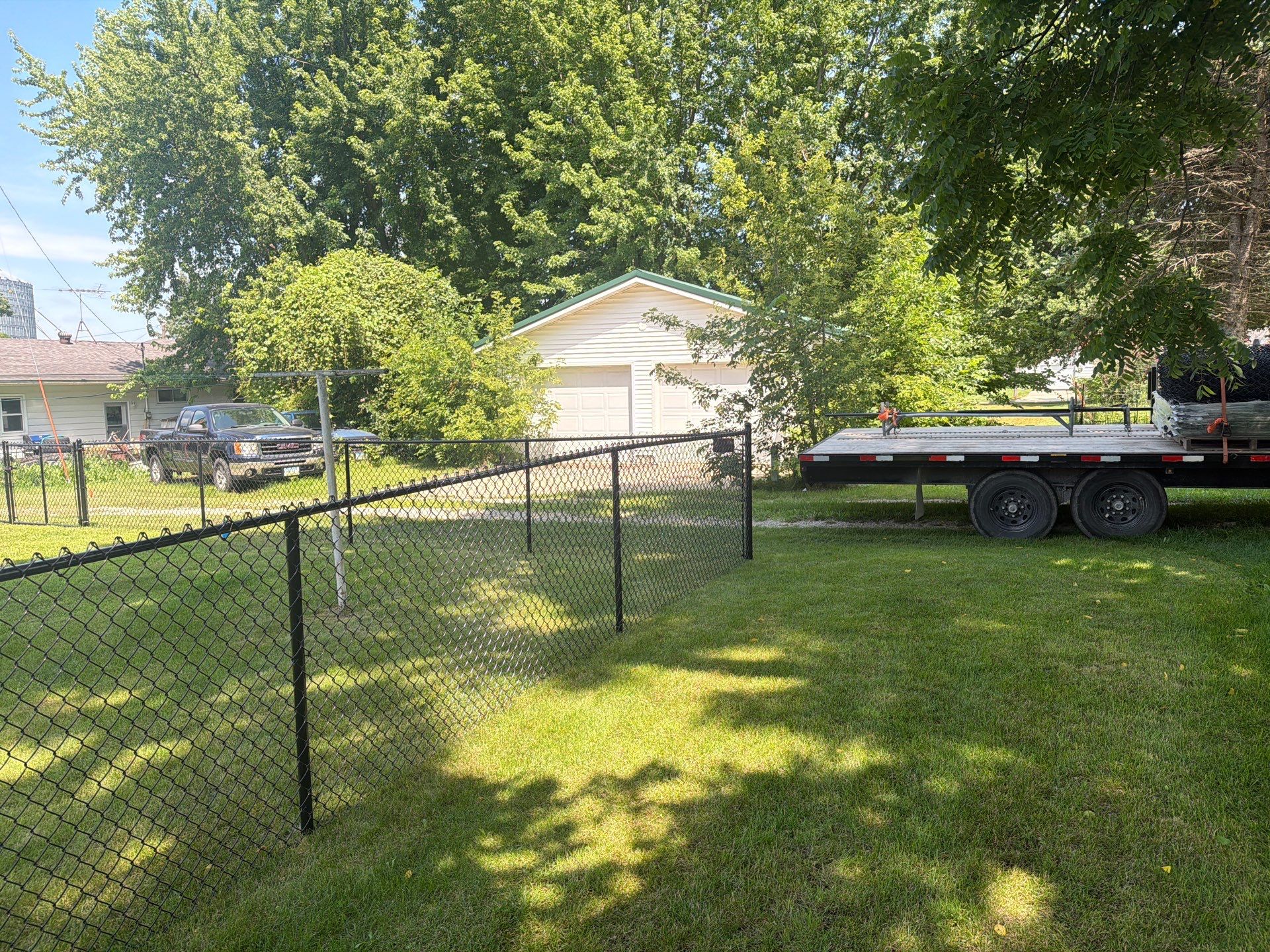 Black Chain Link Backyard Fence Installation in Tripoli, IA by Perfect Picket Fence and Stain