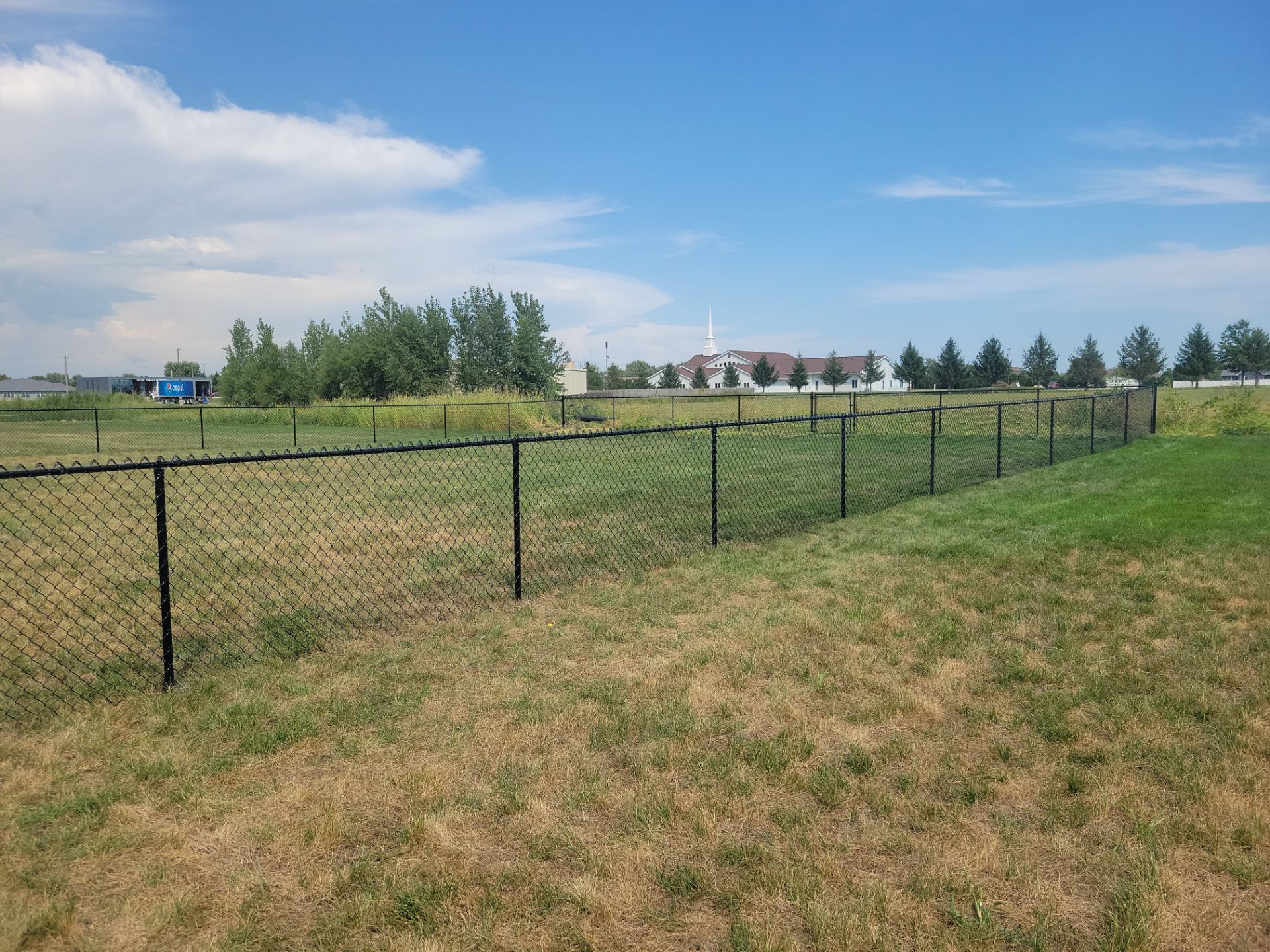 Residential Black Chain Link Fence Installation in Jesup by Perfect Picket Fence and Stain