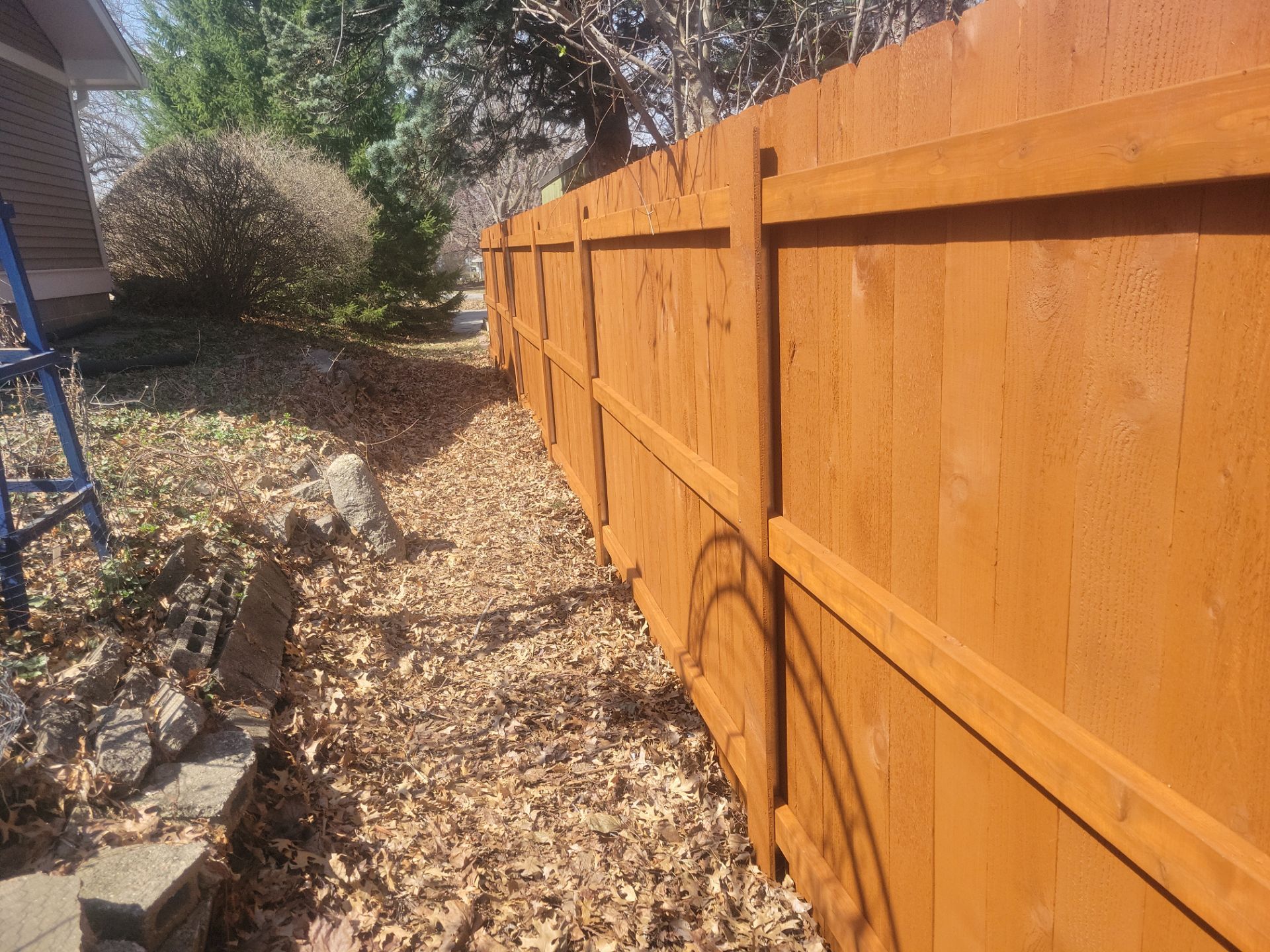 Stained Cedar Wood Privacy Fence Installation in Cedar Falls by Perfect Picket Fence and Stain