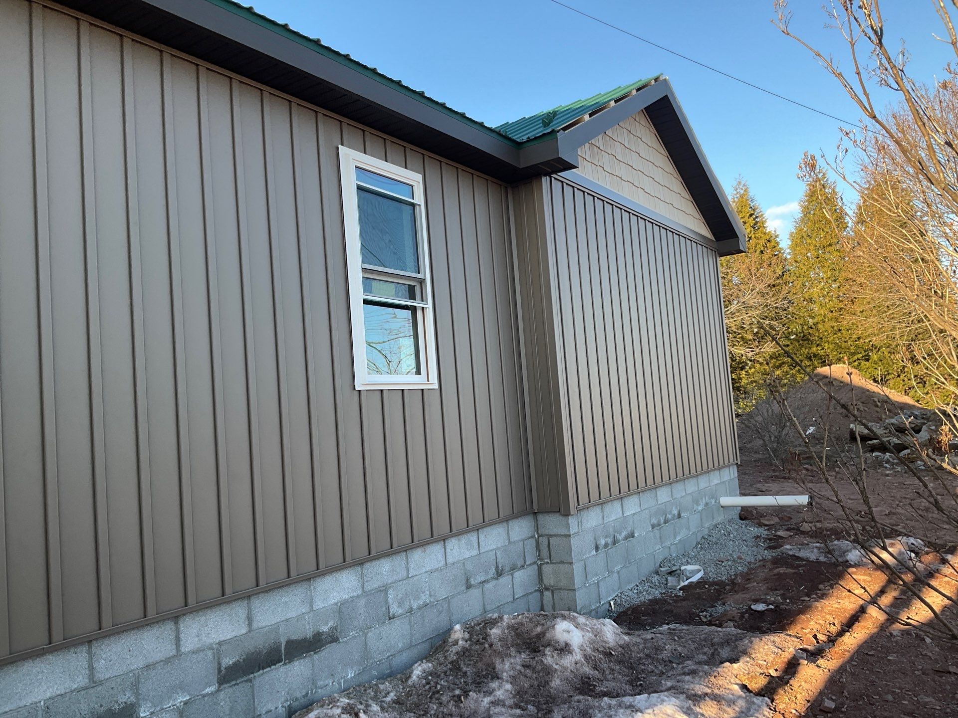 Multi-Story Residential Addition Featuring Textured Metal Siding in Millersburg by Esh Builders