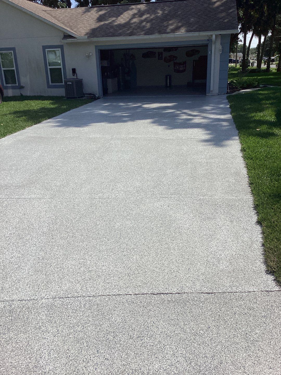 Driveway and Garage using Tidal Wave by Amvet concrete coatings llc