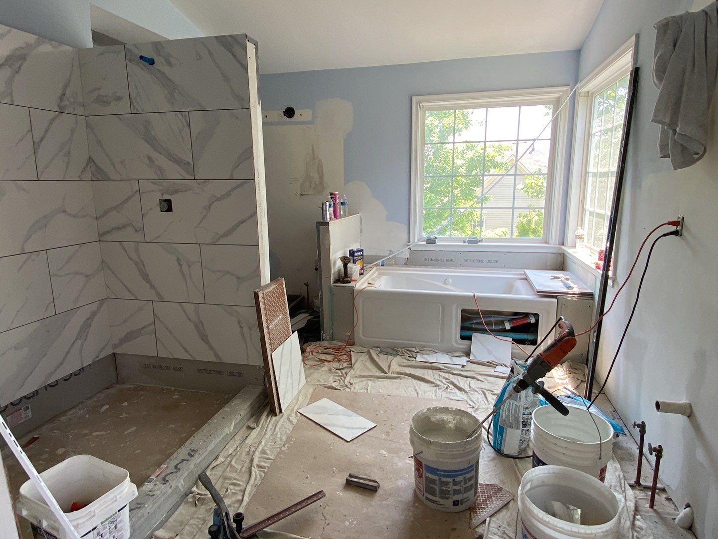 Bathroom Remodel using porcelain tiles , wood make vanetys , mirross , bathroom accessories  by Jesus Master Handyman LLC 