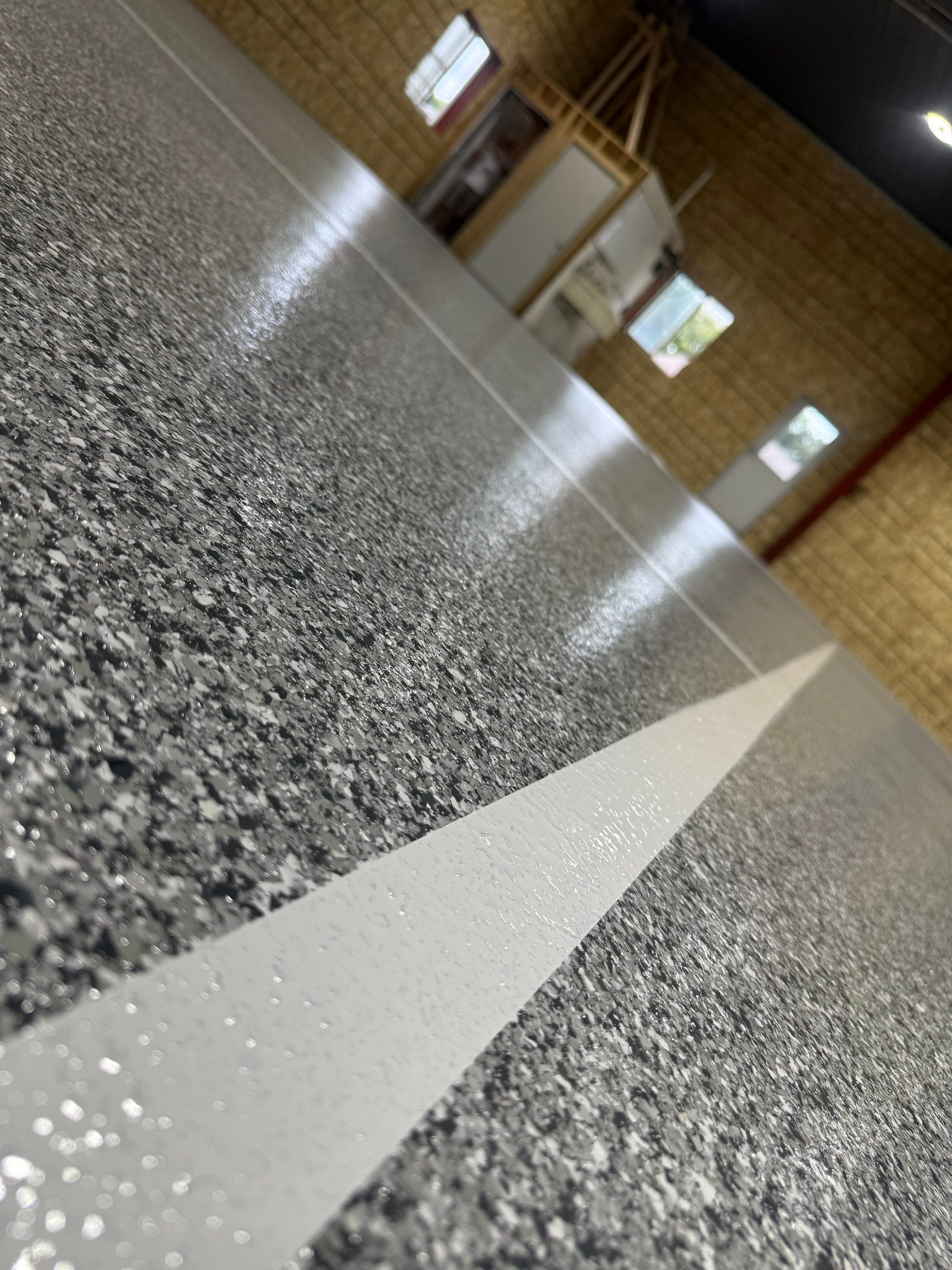 Custom Polyurea Shop Floor with Basketball Court Lines in Rock Valley by Select Painting, Coatings & Garage Cabinets