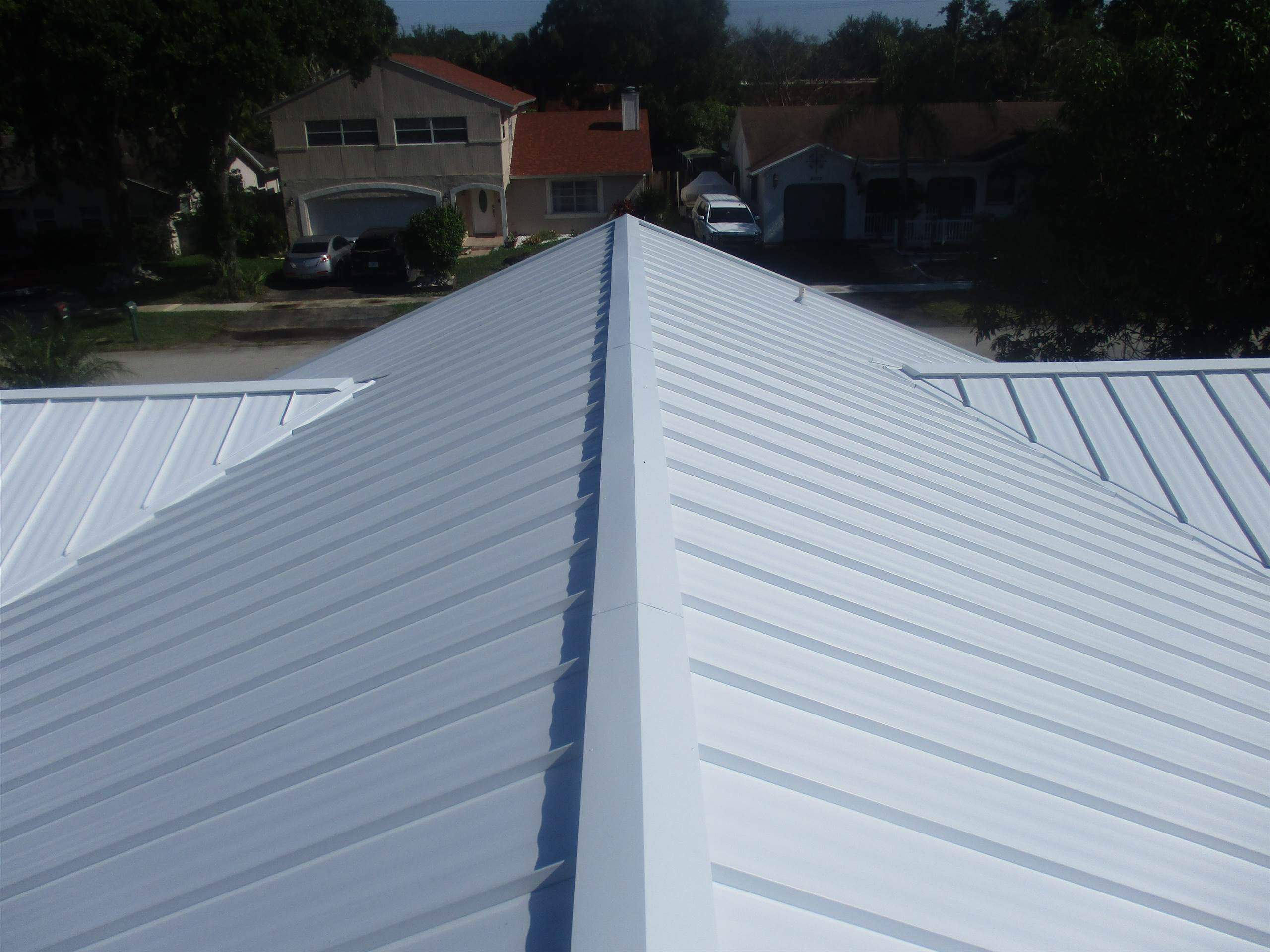 Standing Seam Metal & Flat Re-Roof using 1.5" Nail Strip 24ga Solar White Kynar Coated Standing Seam Metal Panels by Morton Roofing, Inc.