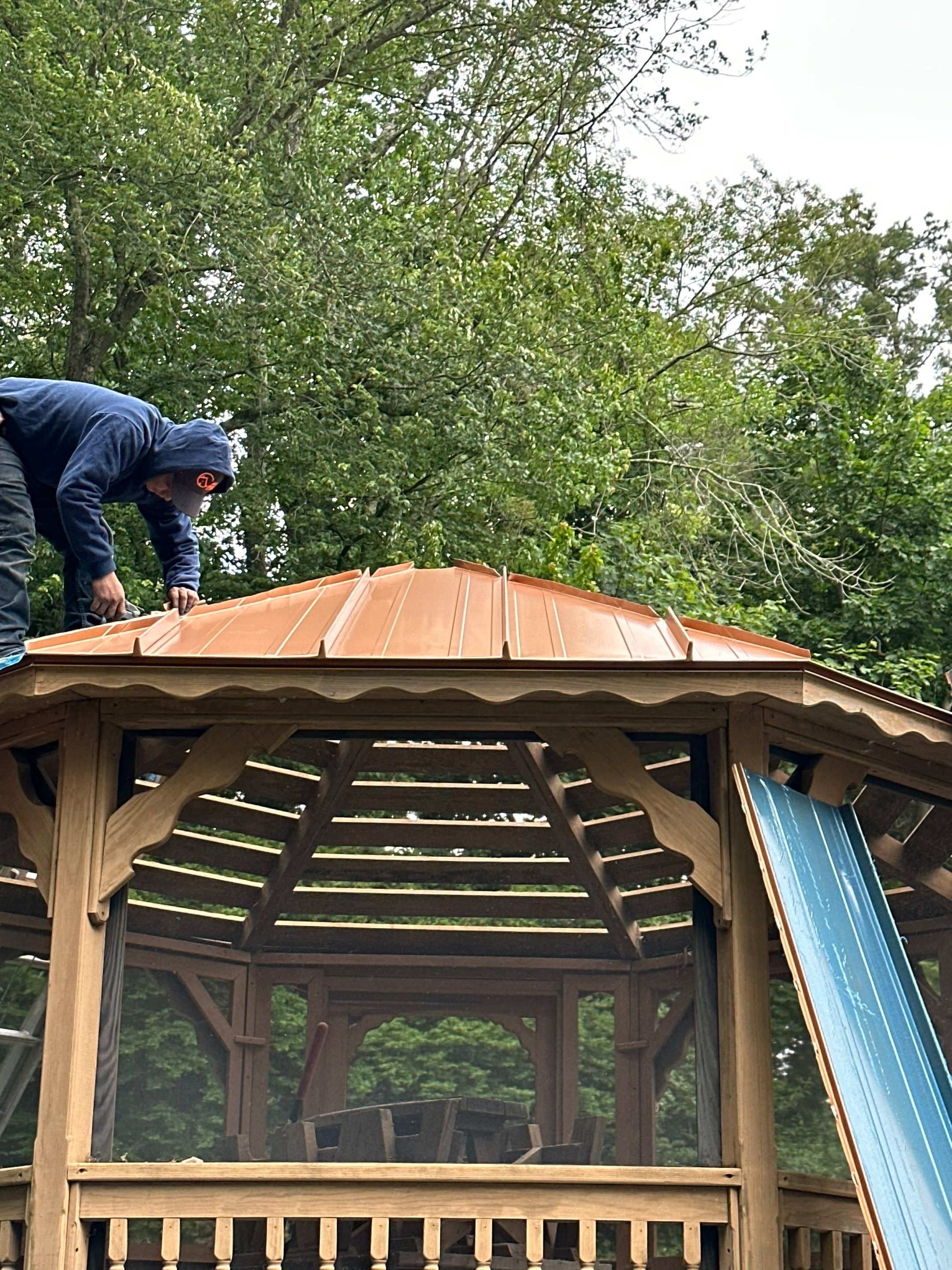 Residential Roofing Installation using Copper Penny Metal Roof by A Plus Exterior