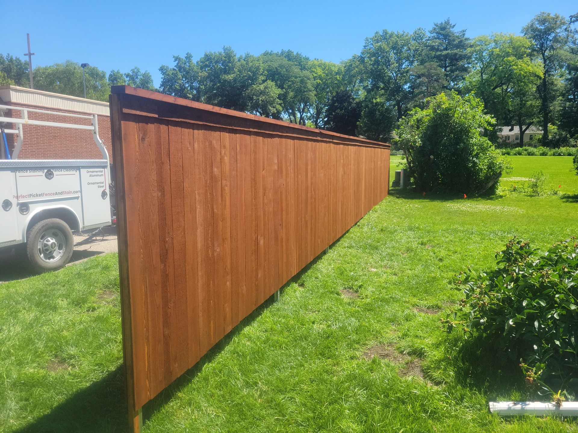 Custom Stained Cedar Chestnut Privacy Fence Installation in Cedar Falls by Perfect Picket Fence and Stain
