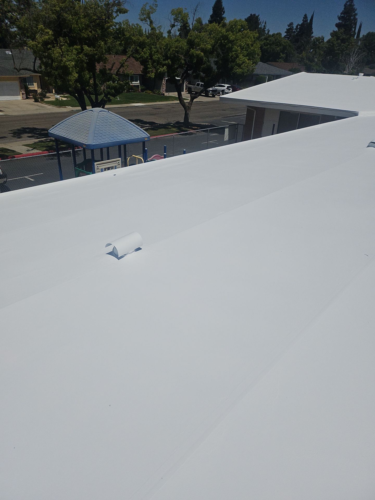 Single-ply restoration system using Benchmark/PUMA XL coatings over TPO single-ply roofing by Straight Edge Roofing Inc