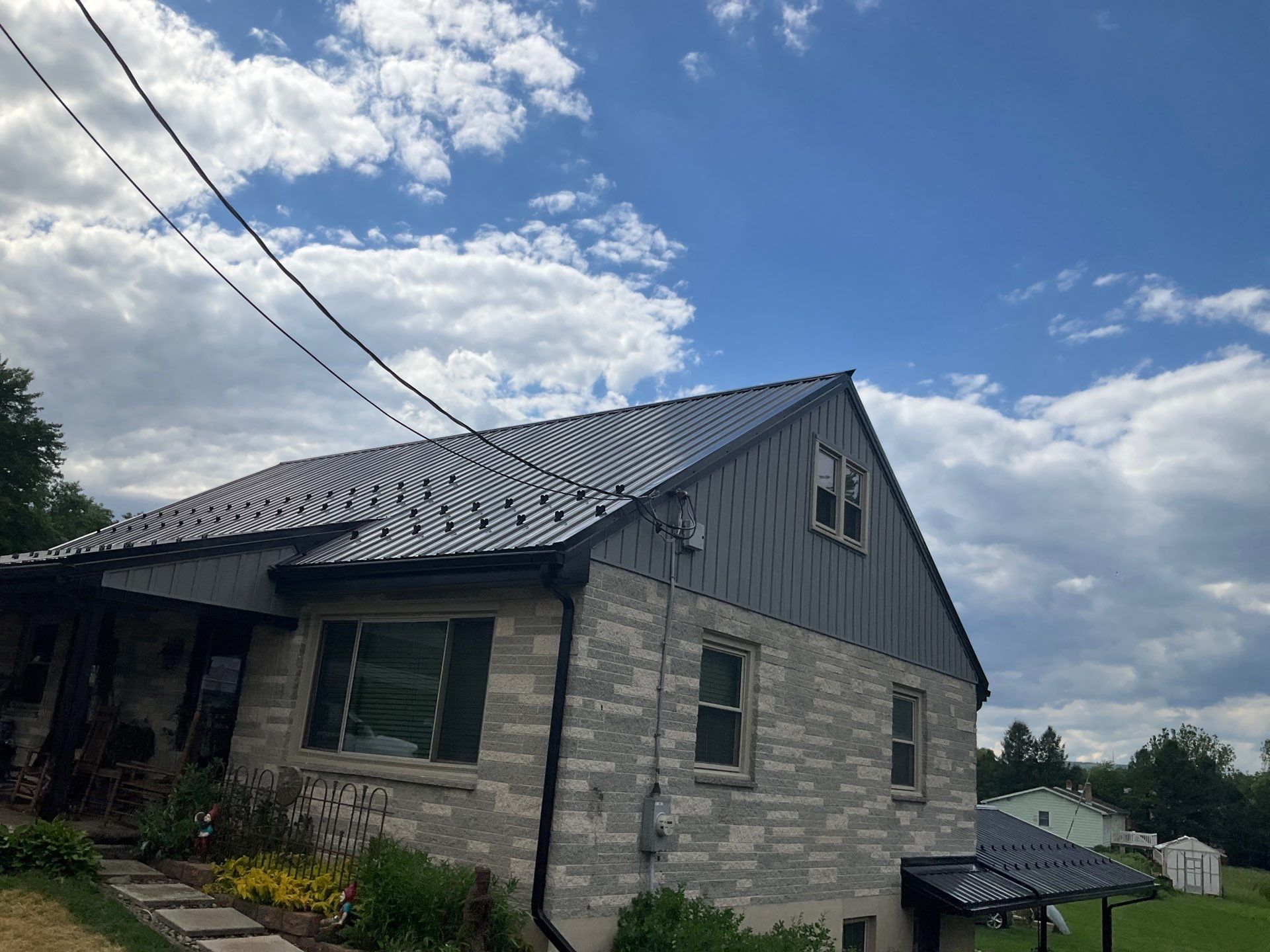 Metal Roofing, Board & Batten Siding, and Entry Door Transformation by Esh Builders