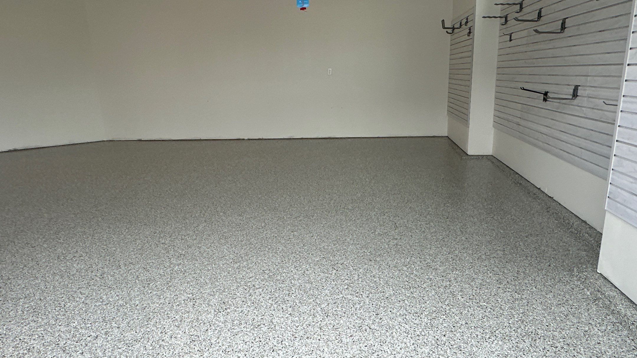 Jon S. transformed his garage with a new floor, slotwall & Cabinets! by Banner Garage
