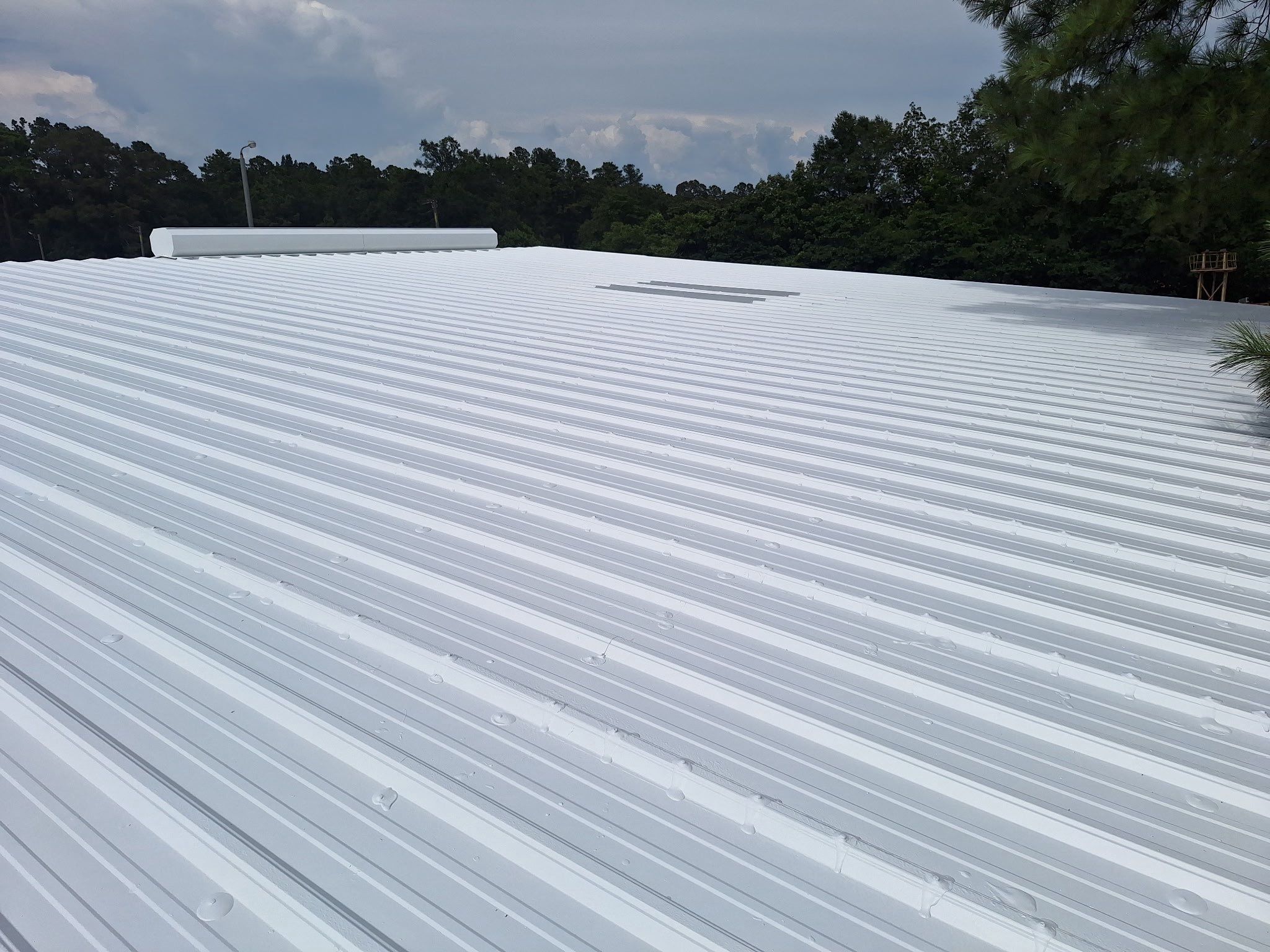 Commercial Metal Roof Restoration with White Protective Coating by Southern Roof Solutions