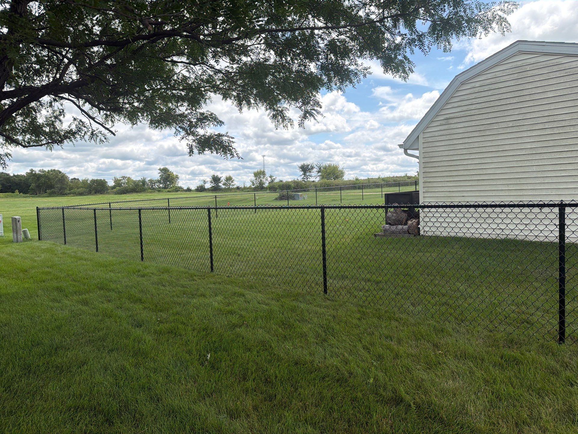 Black Vinyl-Coated Chain Link Fence Installation in Fairbank by Perfect Picket Fence and Stain