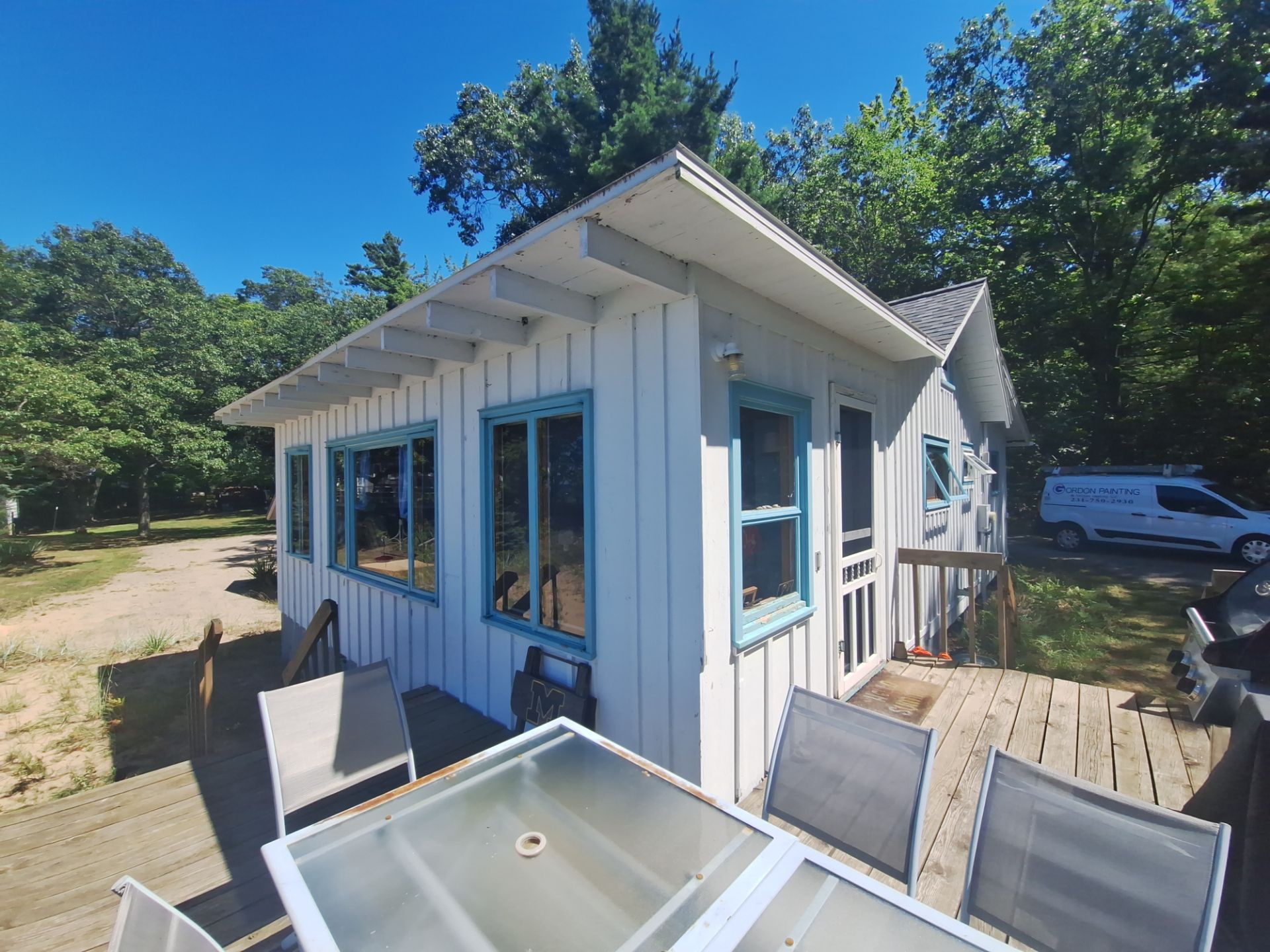 Lakeside Cottage Exterior Painting and Teal Trim Restoration in Mears by Gordon Painting