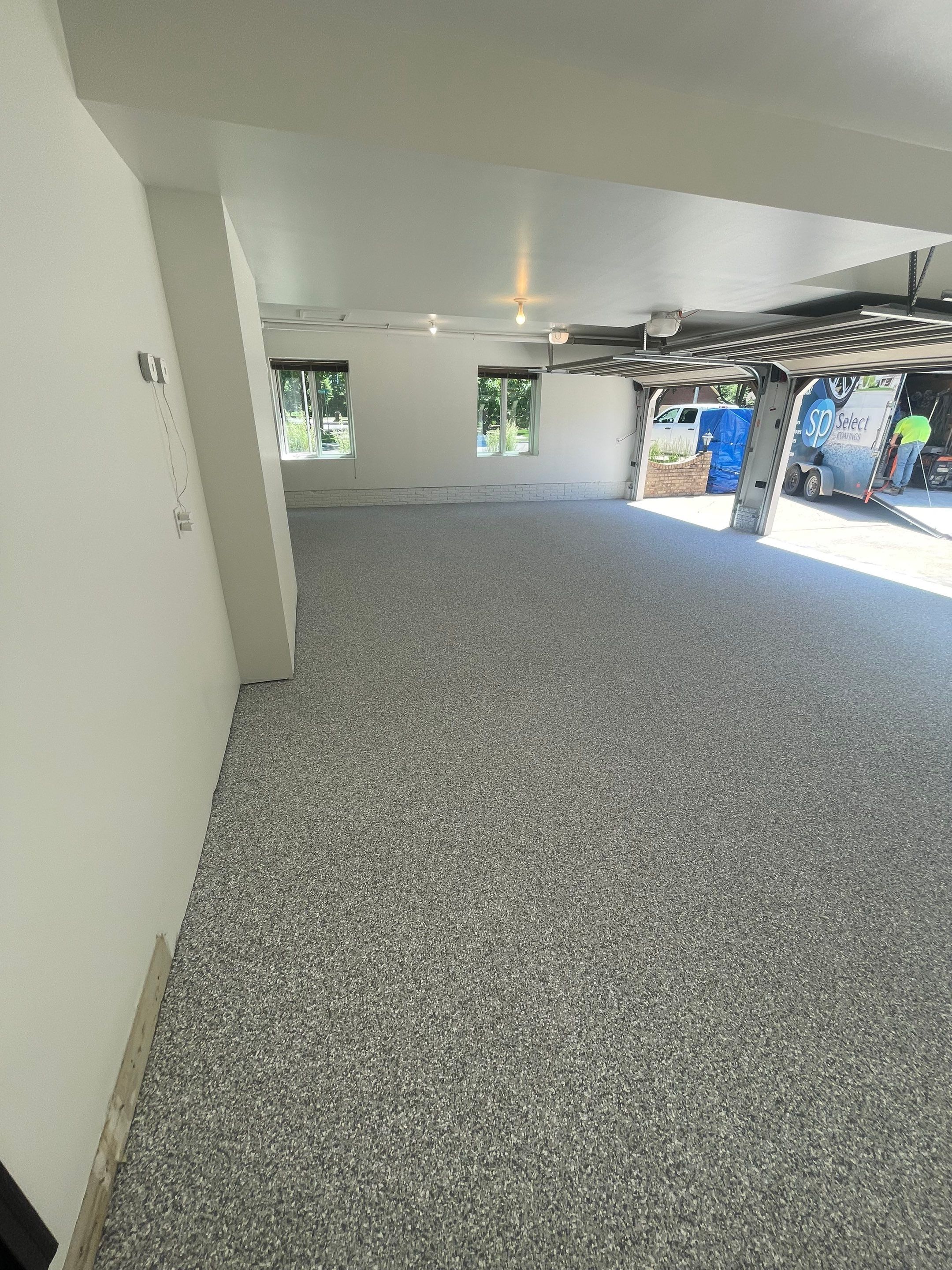 Gray Speckled Epoxy Garage Floor Coating in Sioux Falls by Select Painting, Coatings & Garage Cabinets