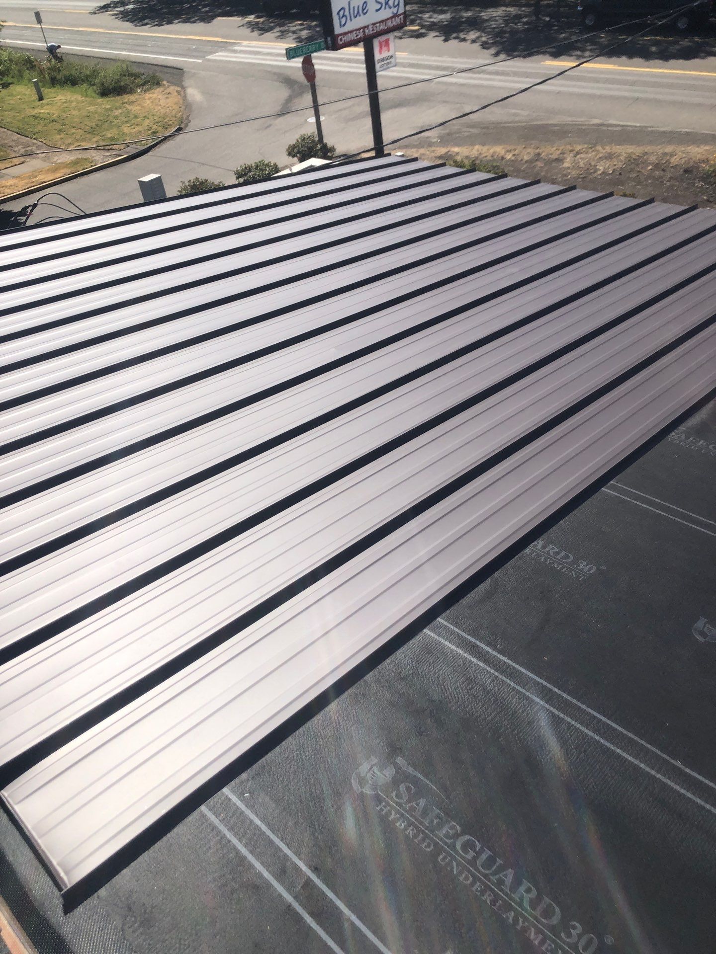 Commercial Flat Roof Installation using Bruce and Dana Snap Lock Metal (Color: Brown) by Orezona Building & Roofing Company, Inc.