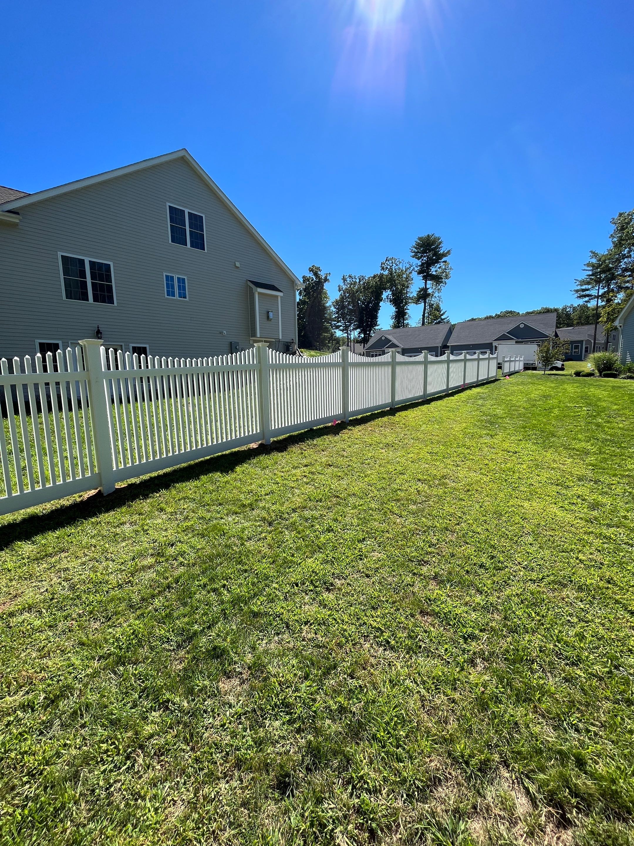New Vinyl picket fence in white by DiGiorgi Roofing and Siding Inc
