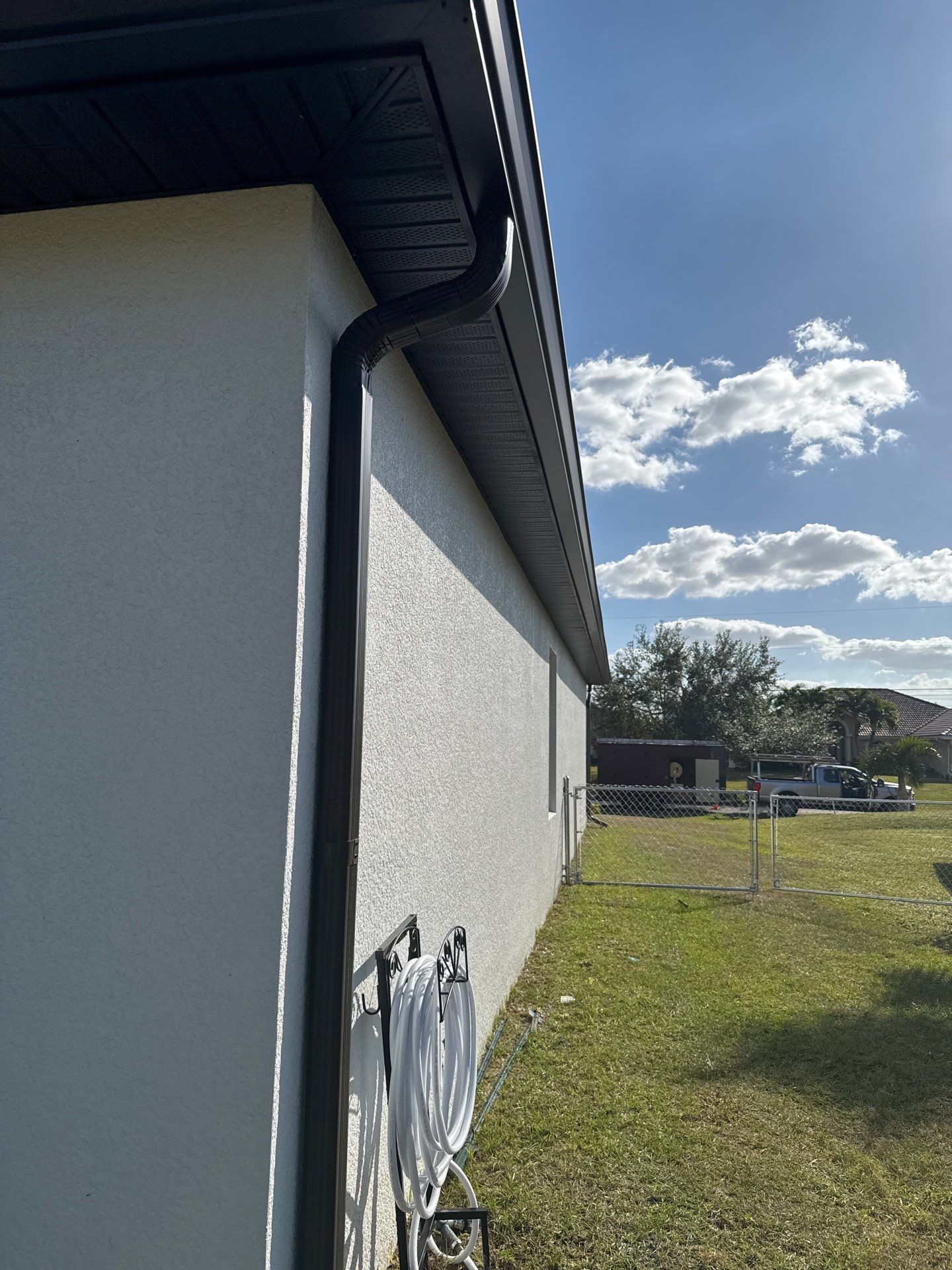 Dark Seamless Gutters and Downspouts in Cape Coral FL by Gutter Professors