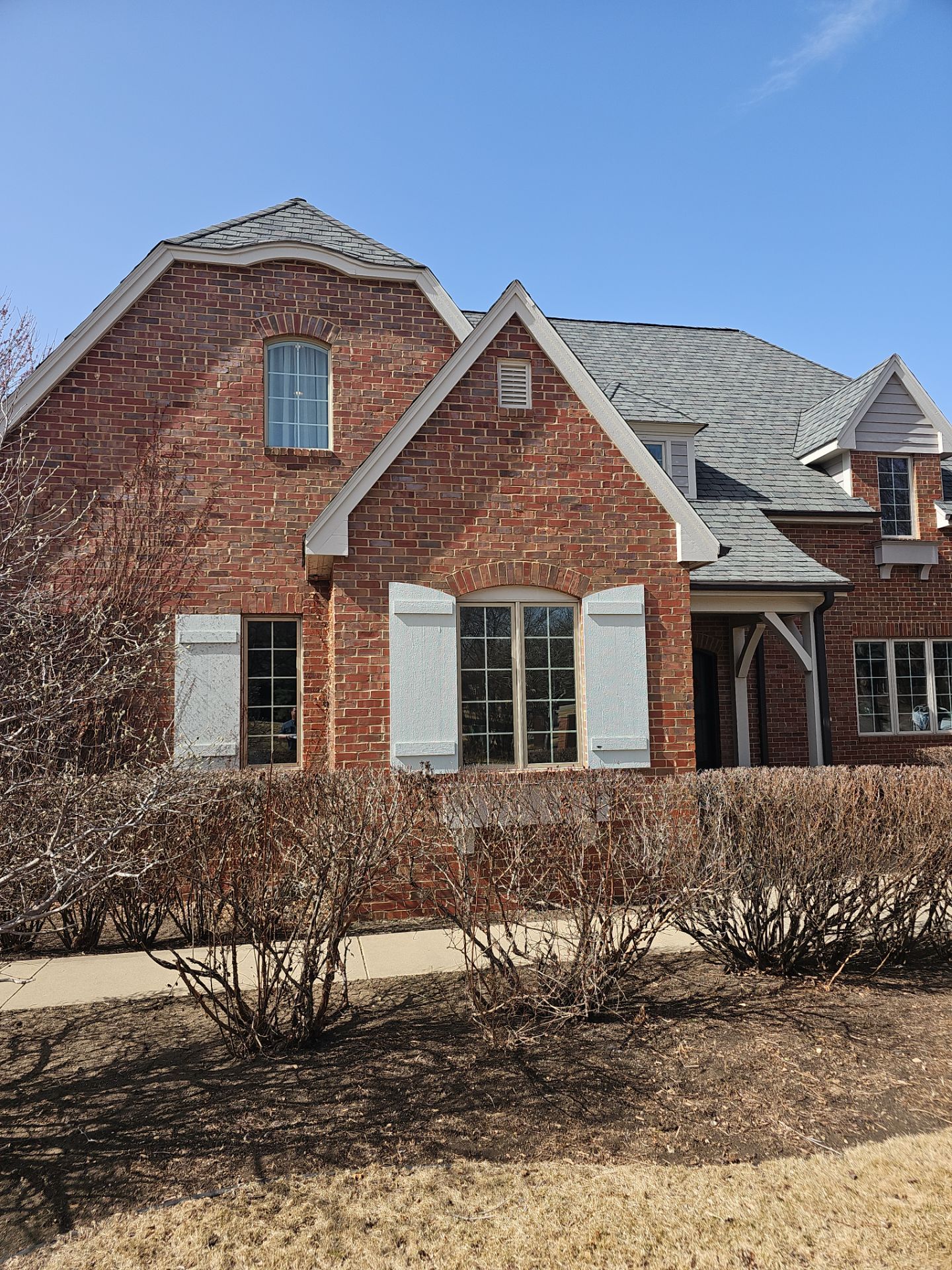 Residential Exterior Brick Painting and Limewash Refresh in Sioux Falls by Select Painting, Coatings & Garage Cabinets