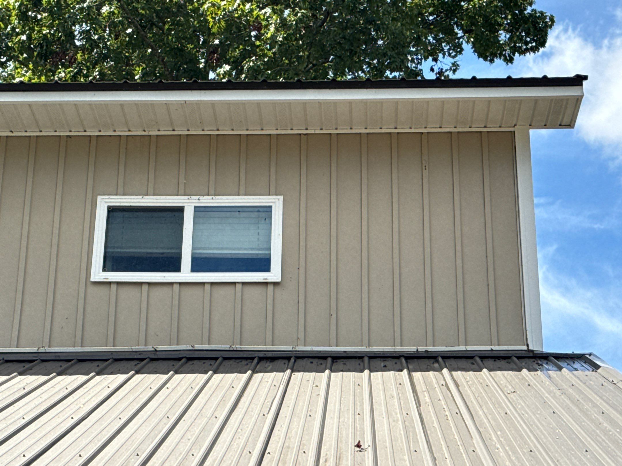 the service shown is cleaning the exterior siding and roof surfaces with pressure washing techniques