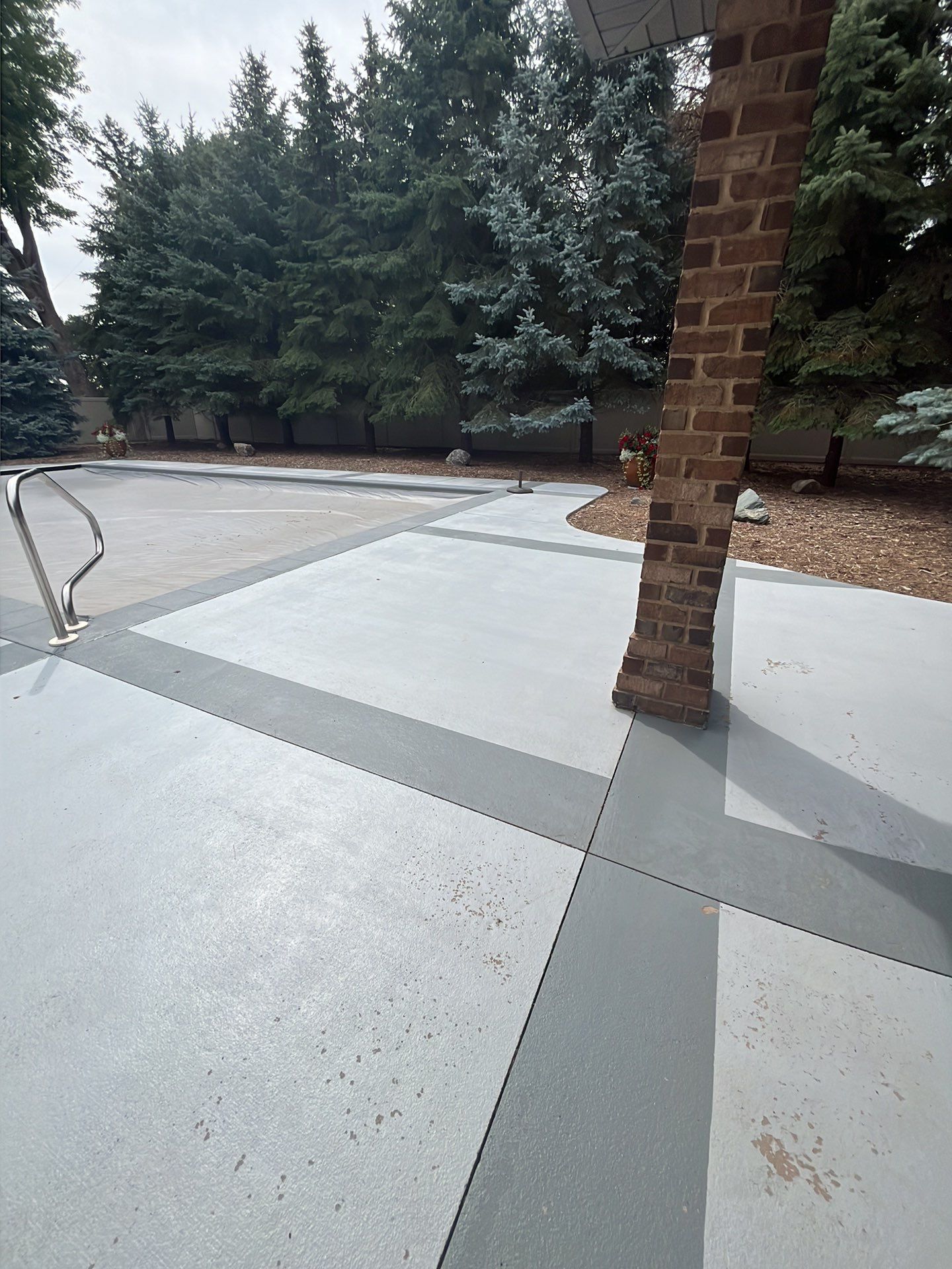 Decorative Concrete Pool Deck and Patio Resurfacing in Sioux Falls by Select Painting, Coatings & Garage Cabinets