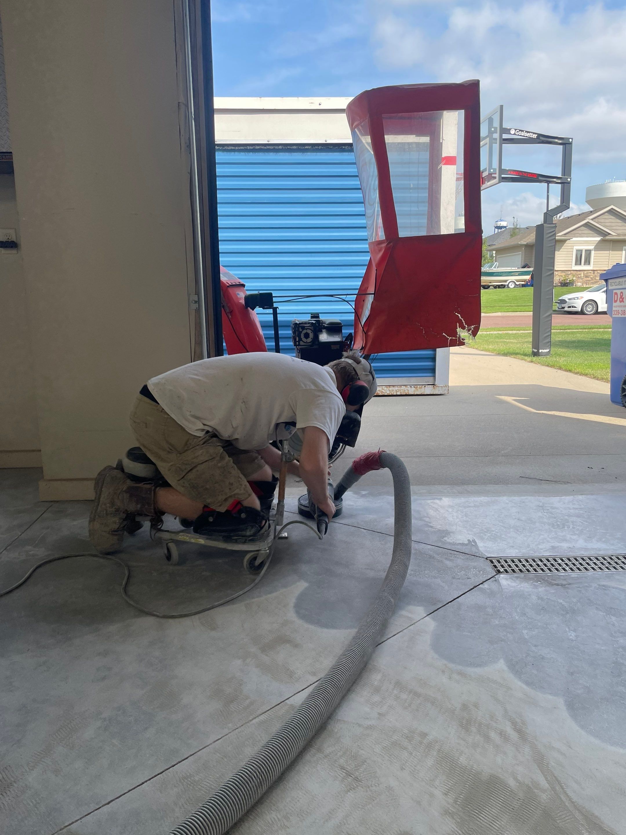 Coyote Flake Garage Floor Coating in Sioux Falls with Trench Drain by Select Painting, Coatings & Garage Cabinets
