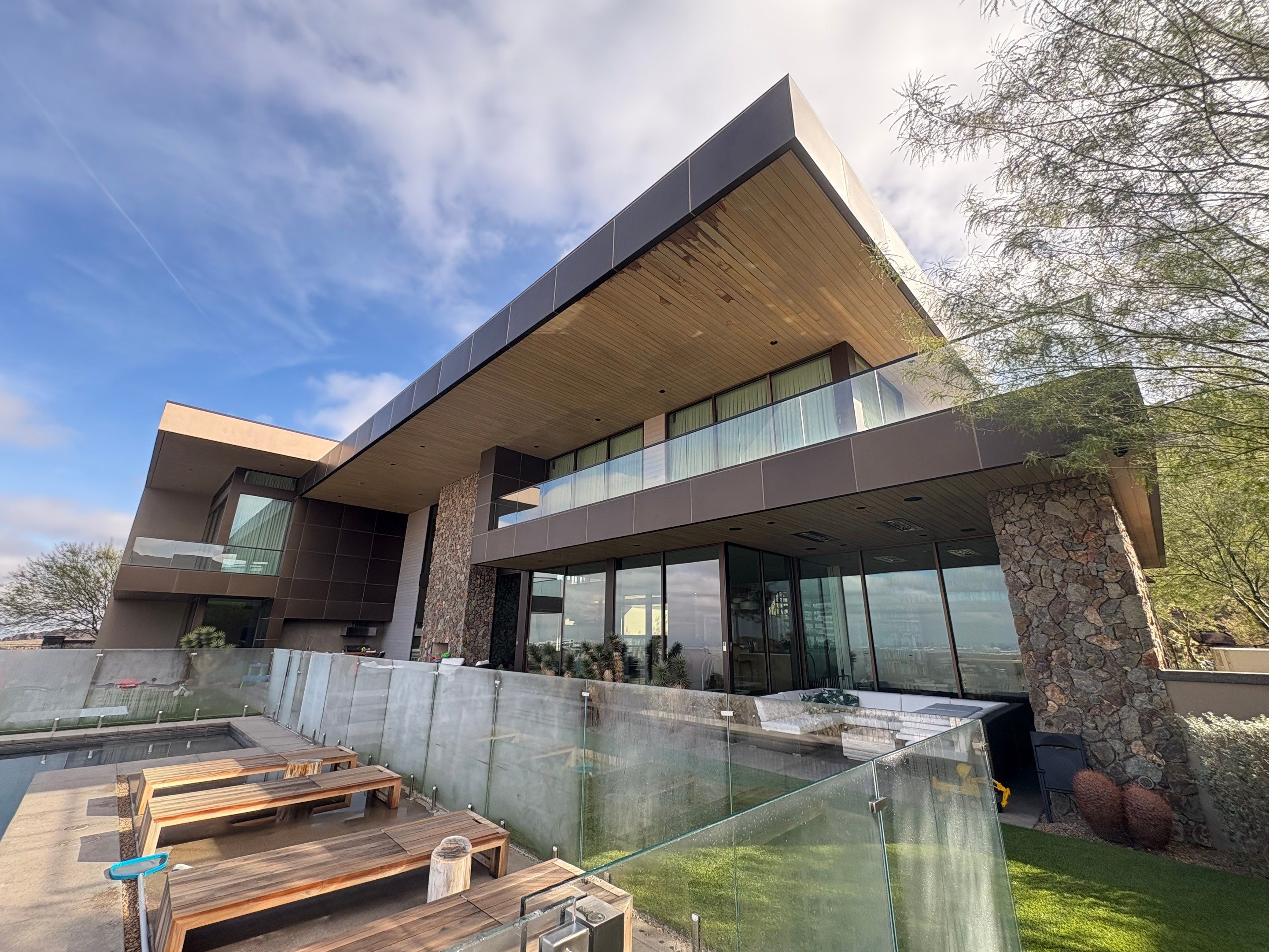Exterior wood refinish & glass pool enclosure by Level Builders