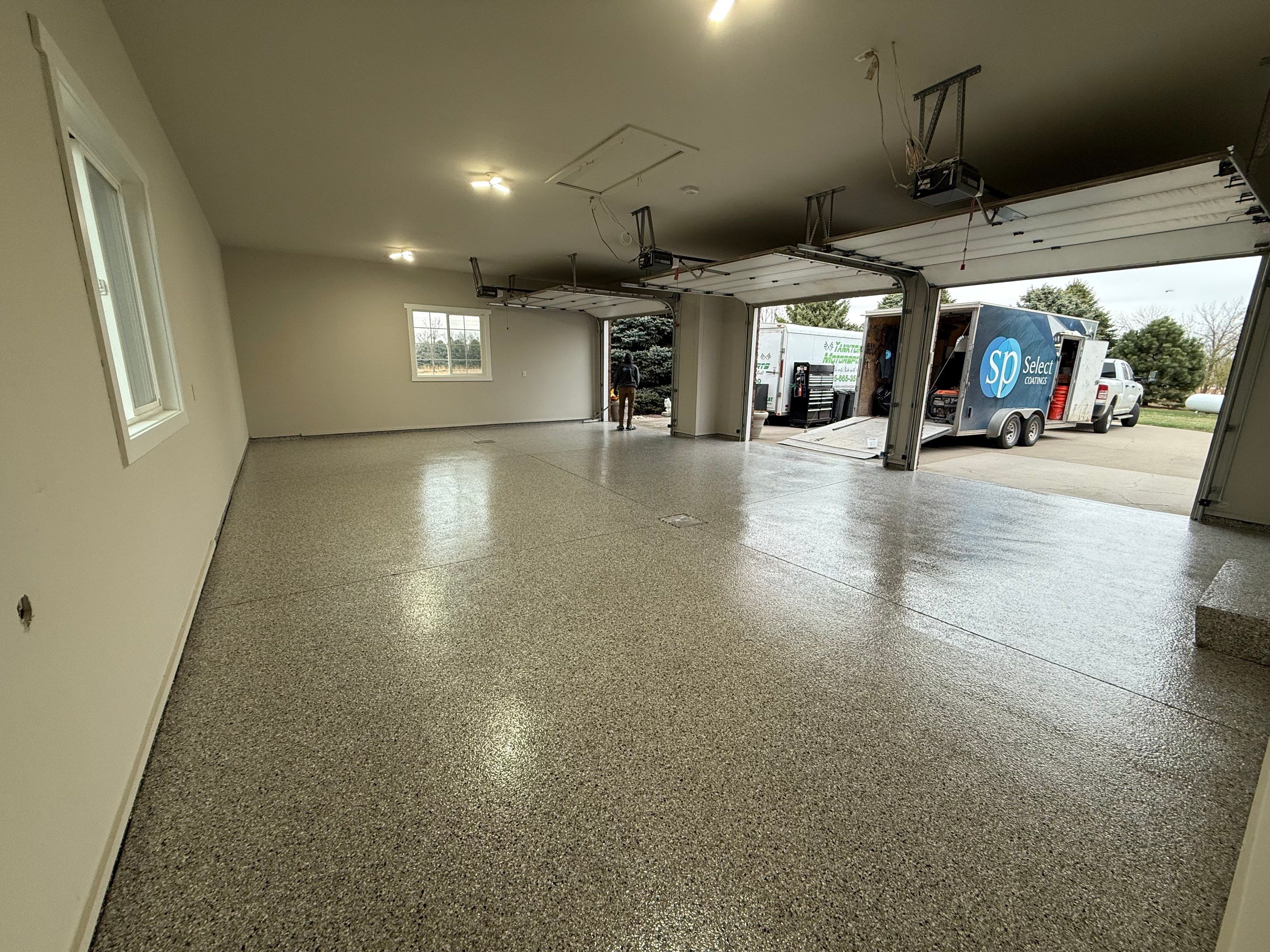 Garage transformation in Yankton by Select Painting, Coatings & Garage Cabinets