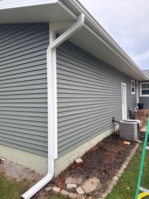 New Aluminum Gutters and White Downspouts for Traverse City Home