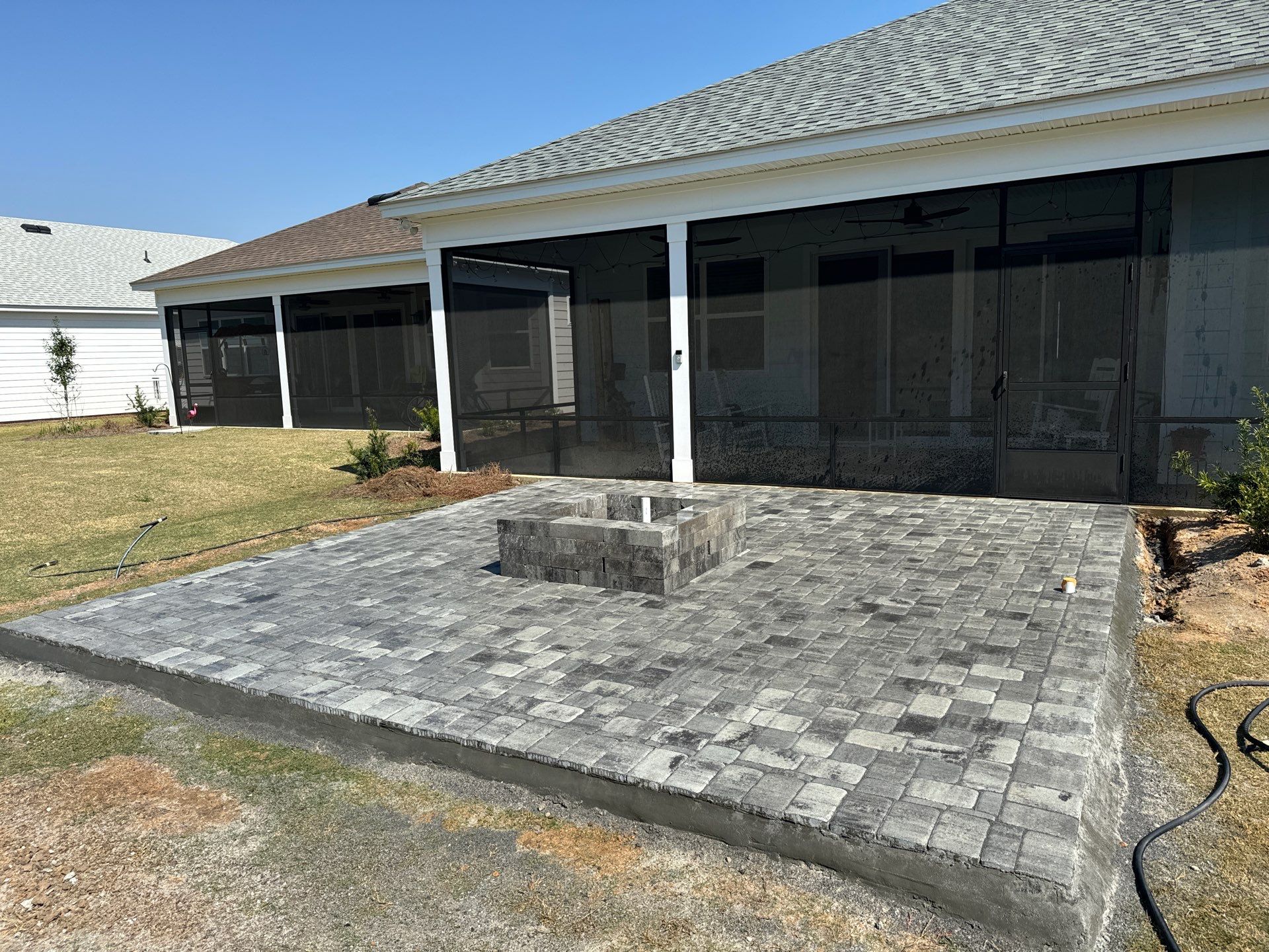 Custom Grey Paver Patio and Square Fire Pit in Hardeeville by Lowcountry Scapes, LLC