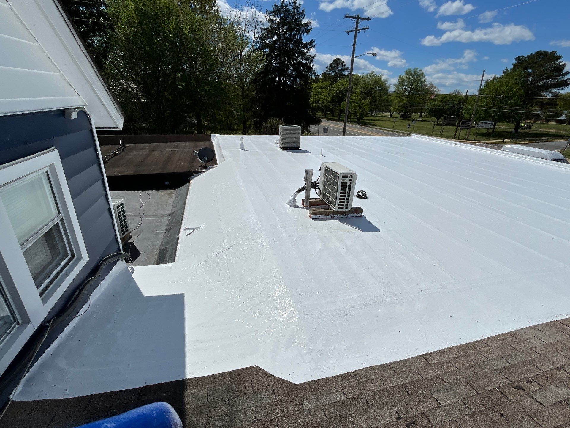 Roof Installation using Silicone Modified Flat Roof Coating by ExteriorPros