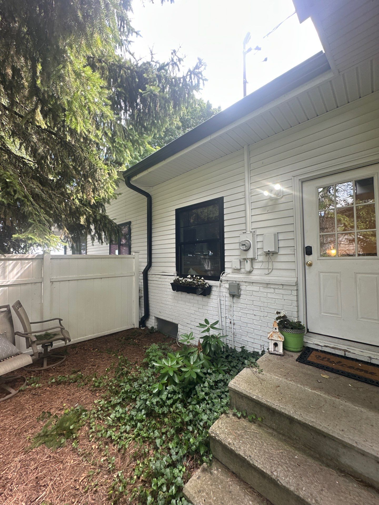 Black Gutter and Gutter Helmet Installation for Suttons Bay Home by Rainbow Seamless Systems