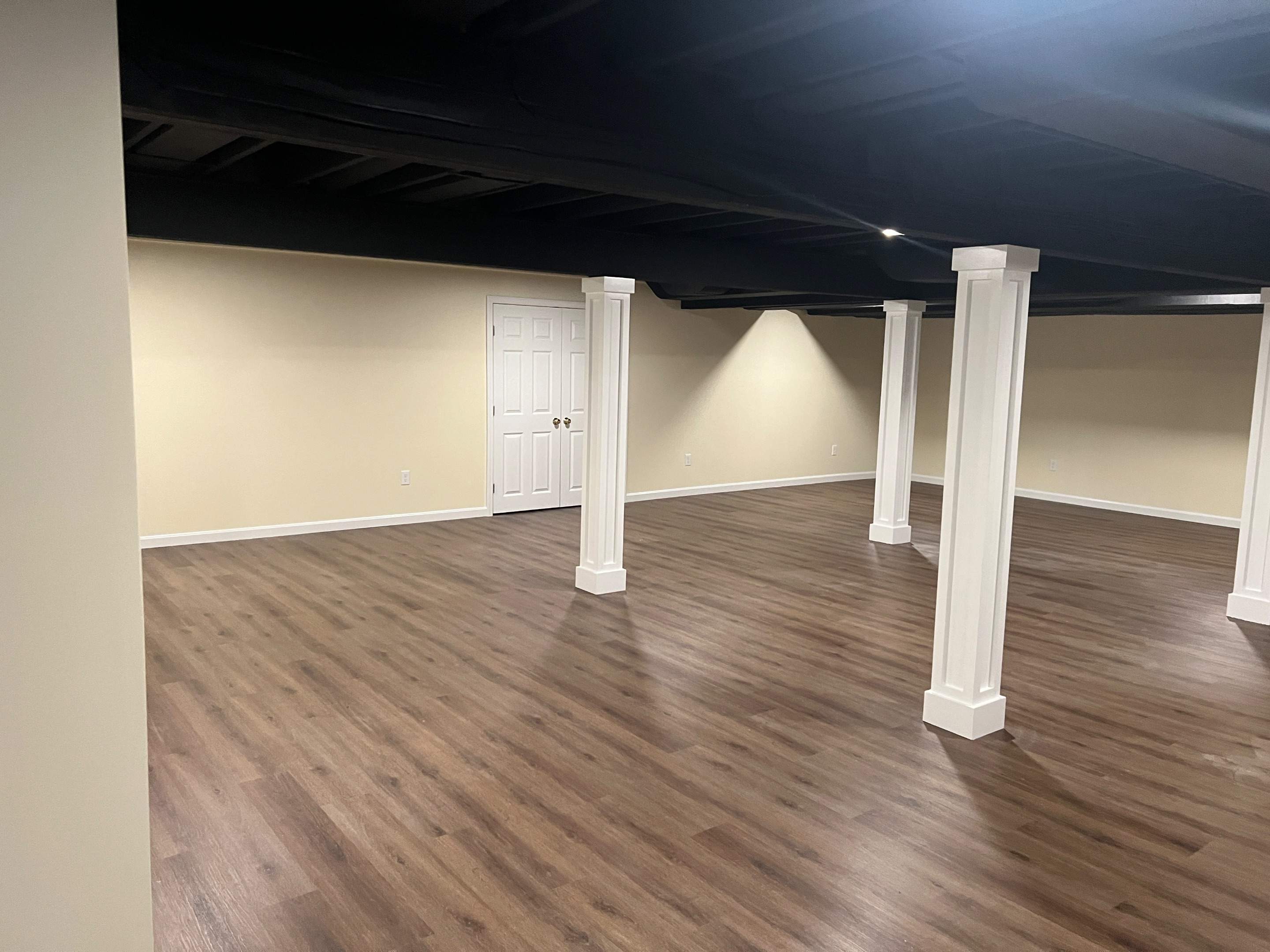 Basement Remodel w/ LVP Flooring & Exposed Ceiling by Chagnon Building & Remodeling LLC