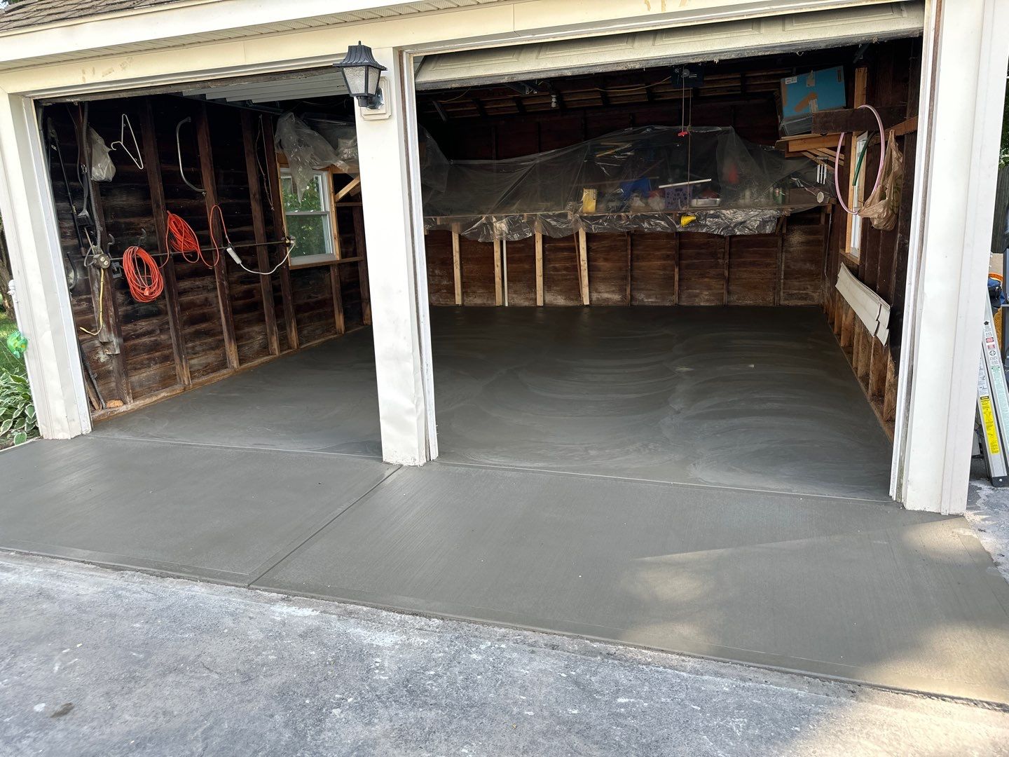 Concrete garage floor replacement with a broom finished apron by NG Masonry & Construction LLC
