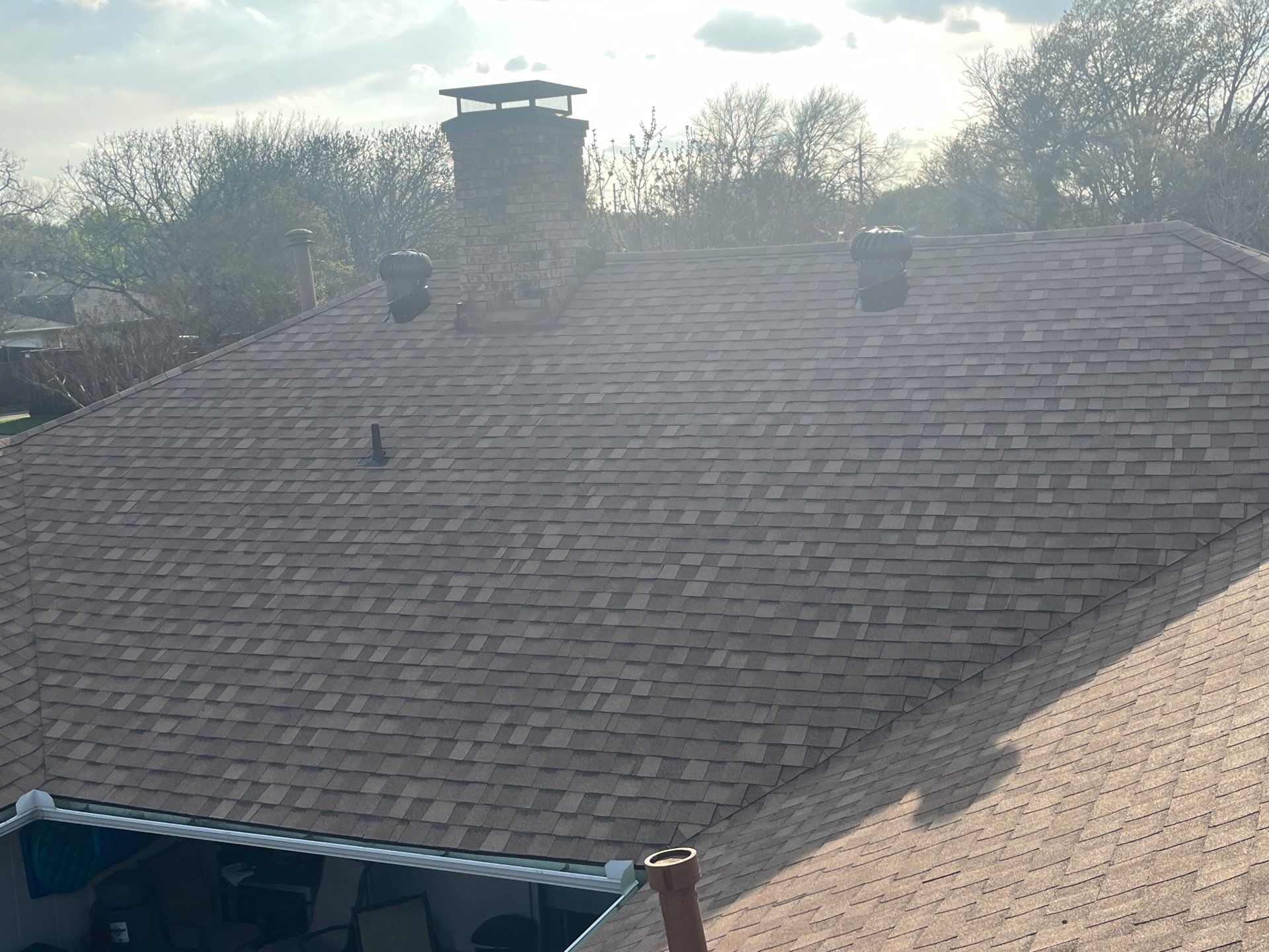 Medium brown brick with Tamko Rustic Cedar by Tejas Roofworks + Restoration