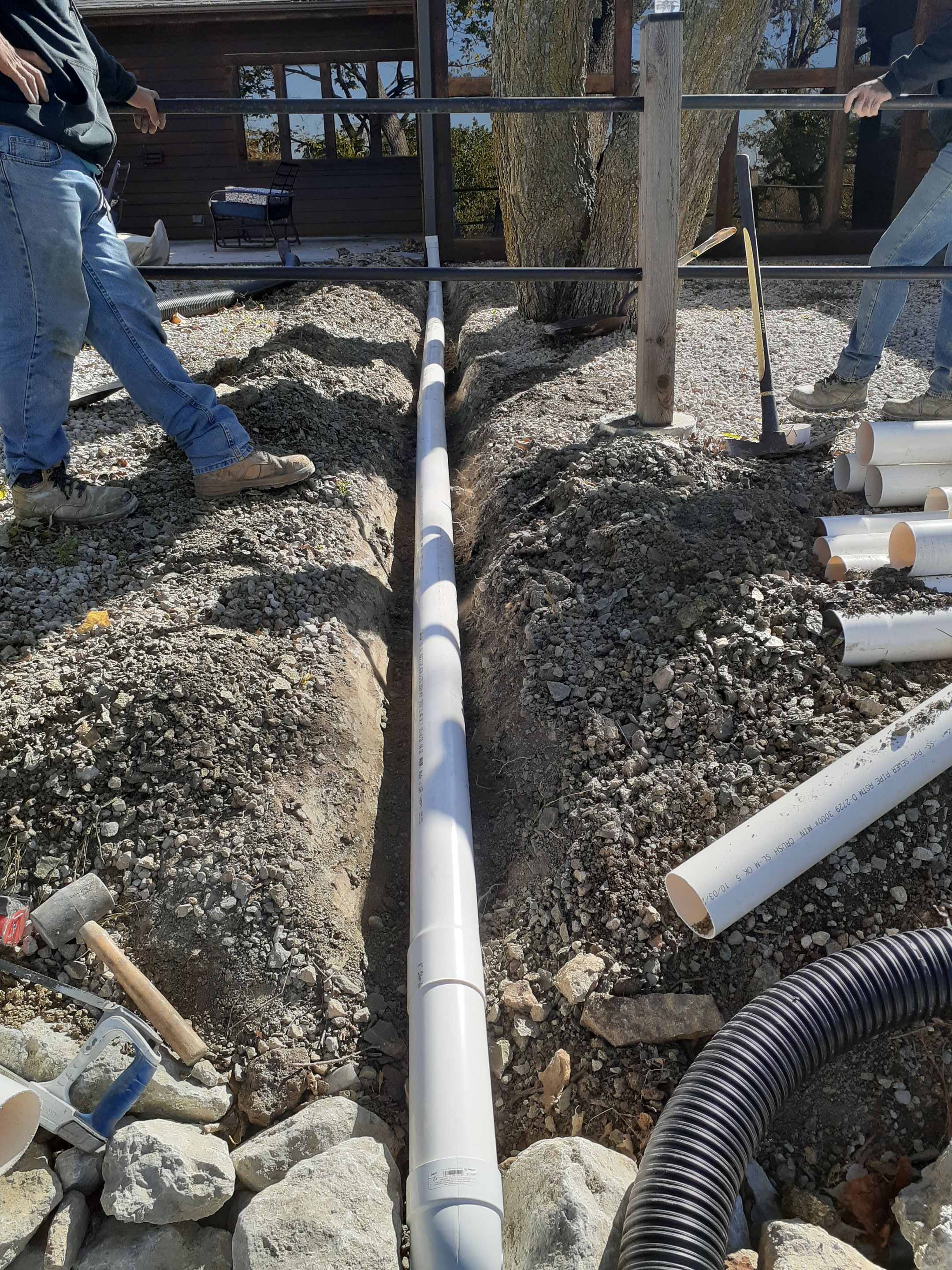 Supporting back of home with backfill at edge of steep creek by LAND ESCAPES LLC