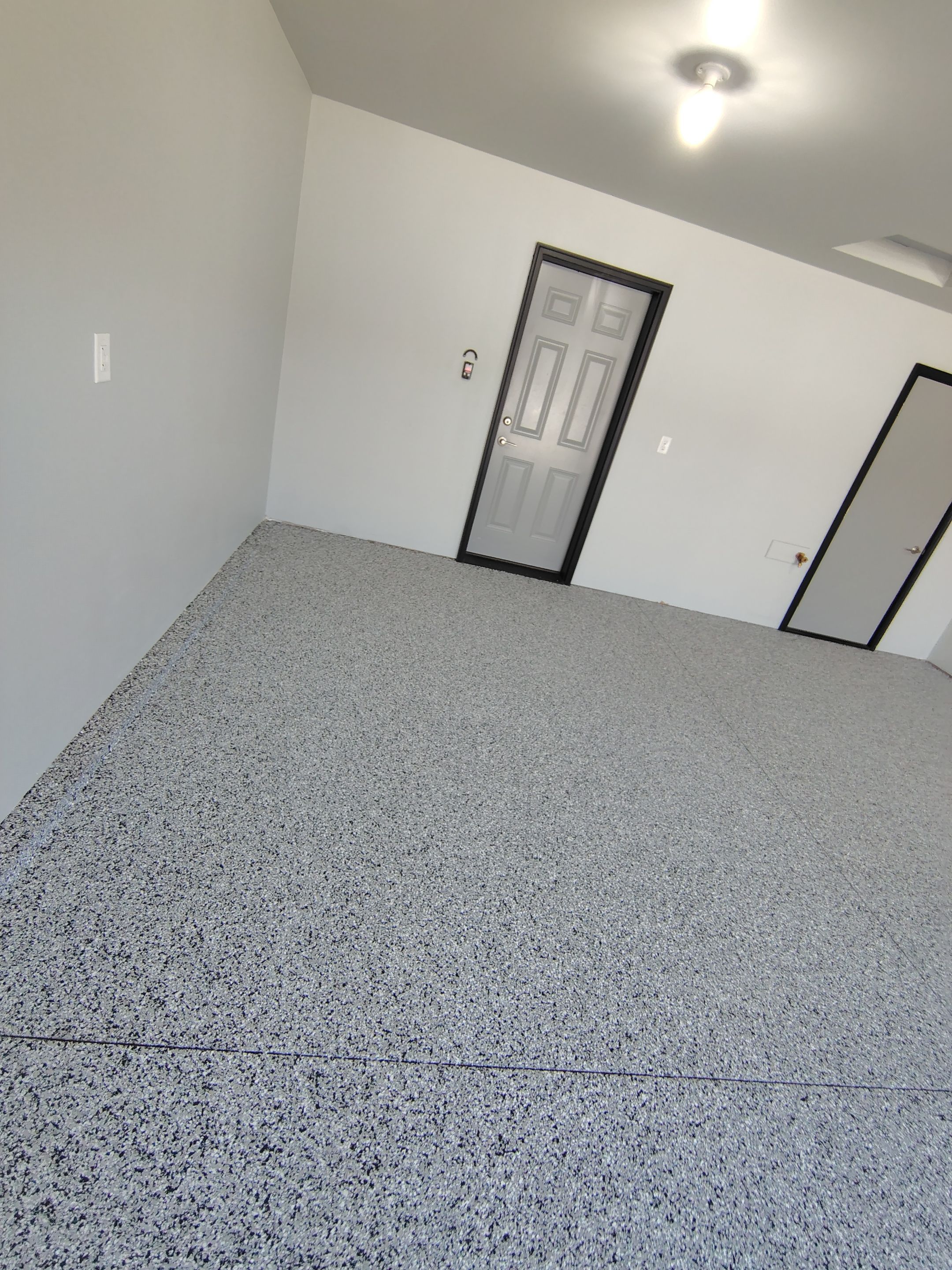 Custom Epoxy Garage Floor Coating Installation in Sioux Falls by Select Painting, Coatings & Garage Cabinets