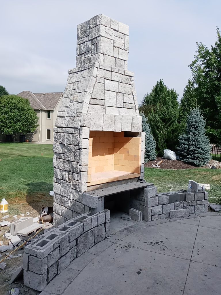 Back Yard Fireplace and Landscape by LAND ESCAPES LLC