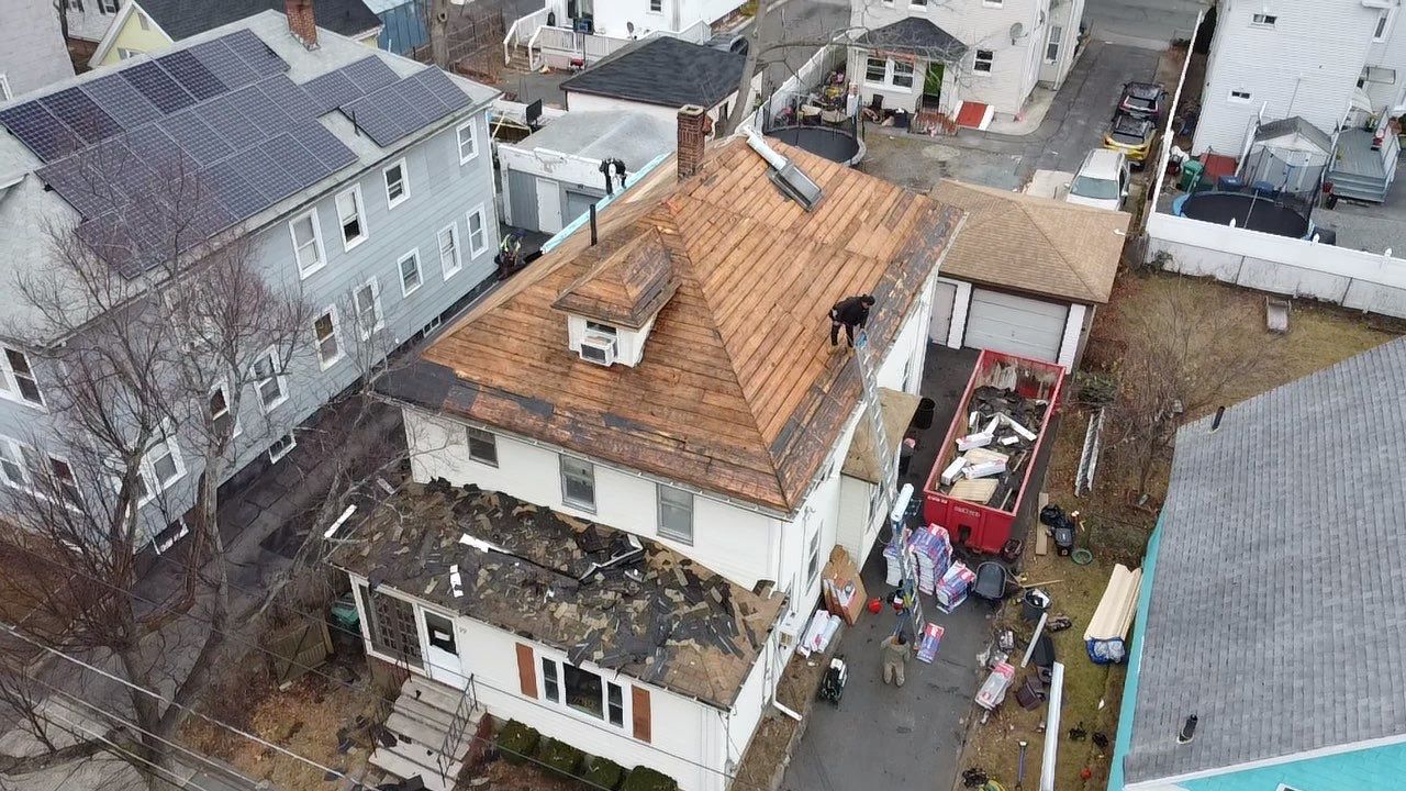 Roof Installation Roof Type: Hip Roof  Multi Family Home- 2 Story by Delarosa Construction & Design