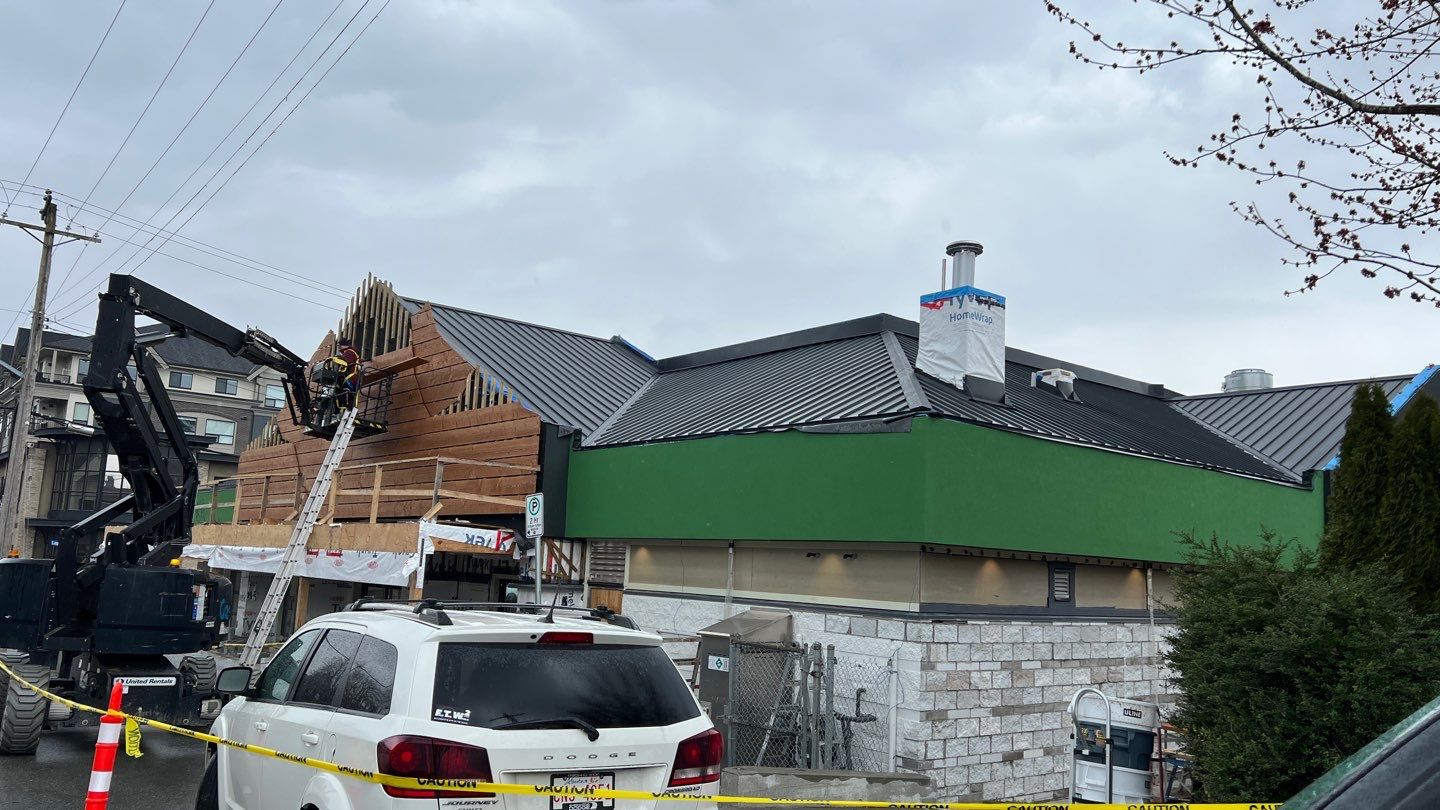 Commercial Roofing Installation using 12" Prolok metal and hidden gutters! by Top Notch Roofing Inc
