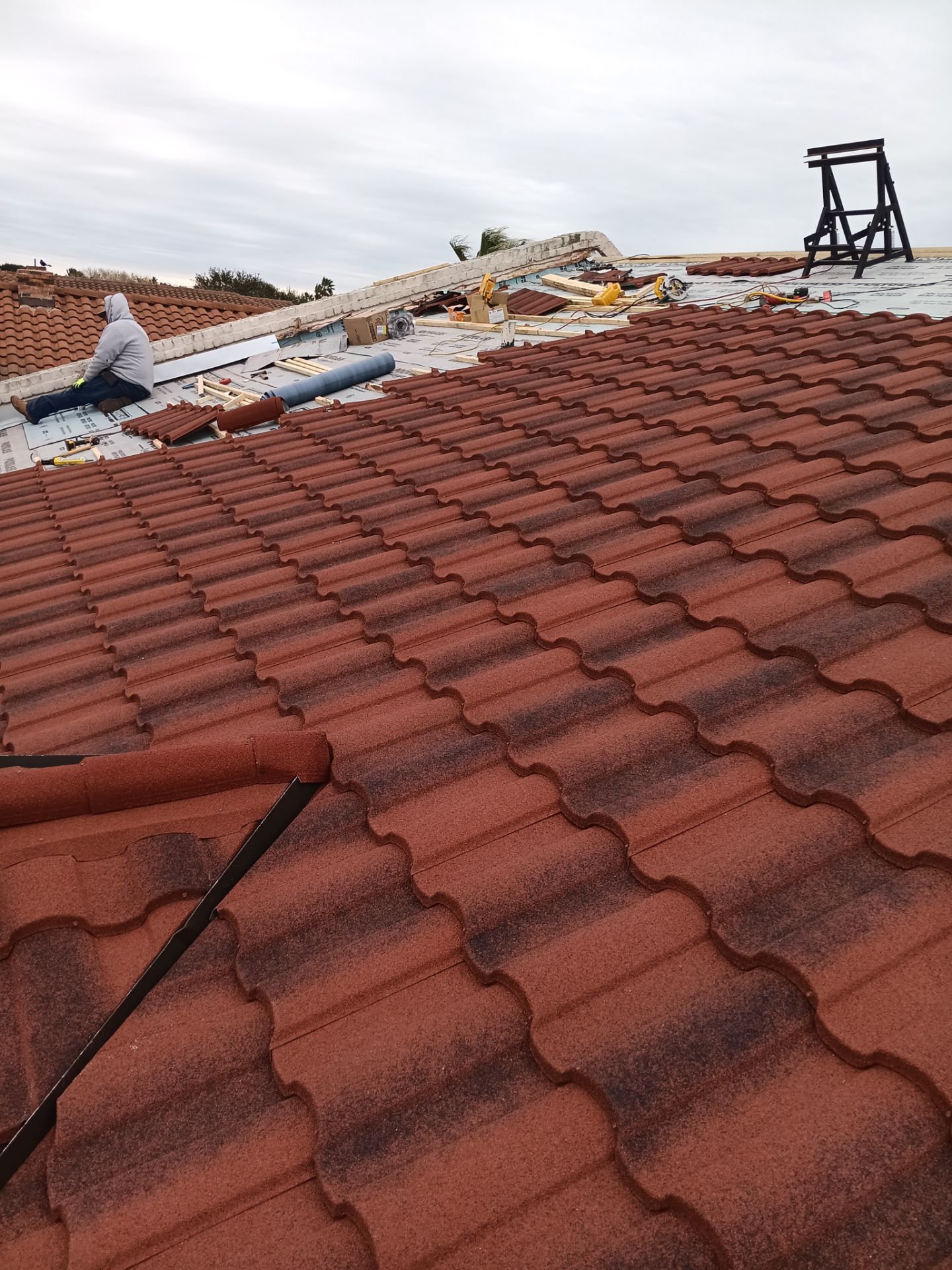 Off with the Tile and on with the TILCOR stone coated metal.  by Bayfront Roofing and Construction