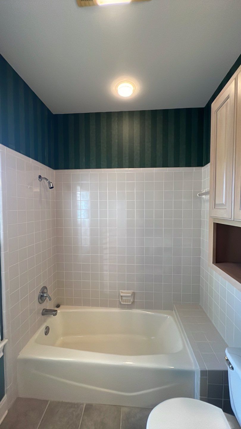 Boerne Guest Bathroom Remodel with Marble Tub Surround & Herringbone Flooring by Legacy Bath and Kitchen