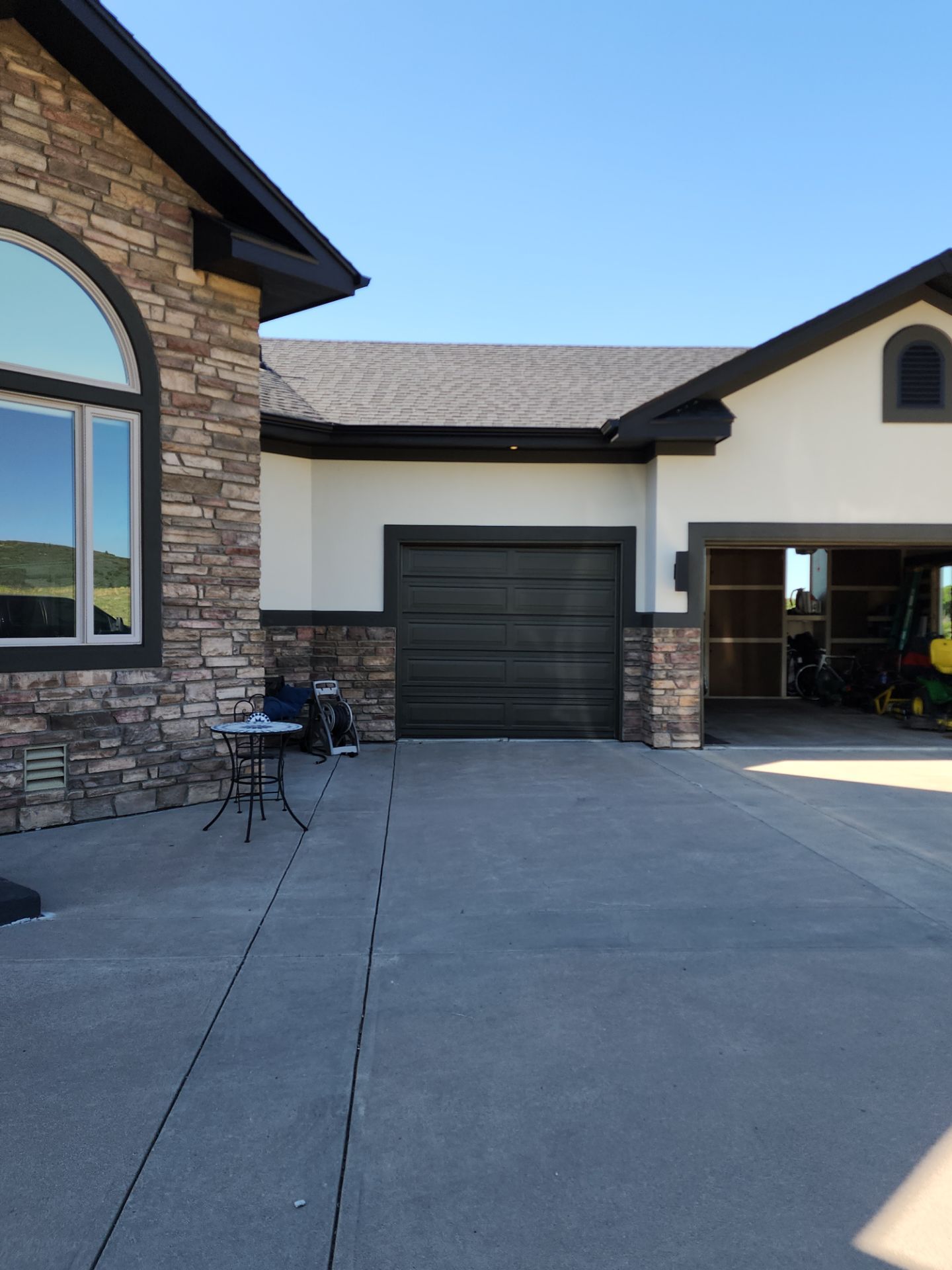 Castle Rock Elegance: White Stucco Exterior with Bold Tricorn Black by J&M Painting LLC