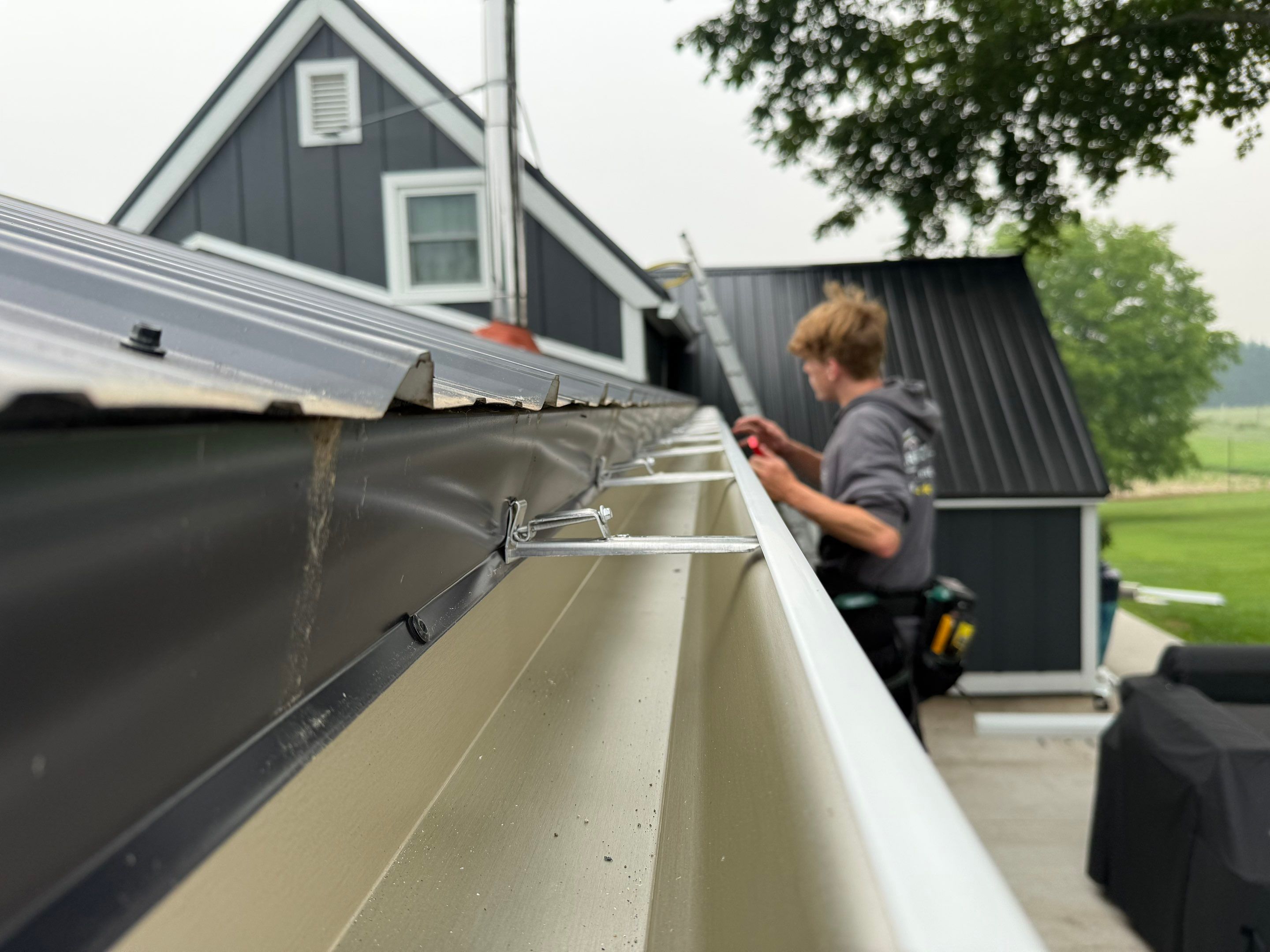 Seamless Gutter and Gutter Helmet Installation on Bellaire Metal Roof by Rainbow Seamless Systems